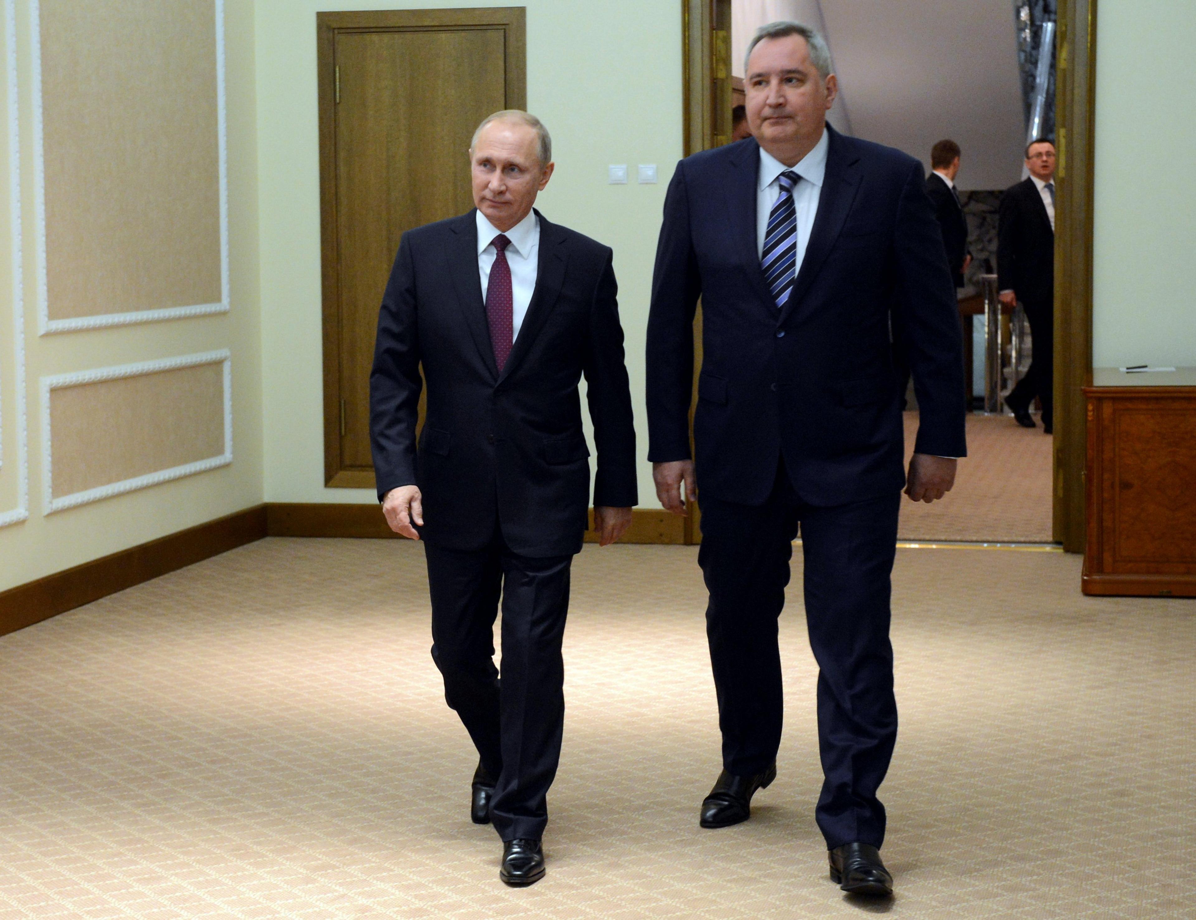 Russian President Vladimir Putin walks with Deputy Prime Minister Dmitry Rogozin during a reception in Moscow, Russia, December 14, 2017