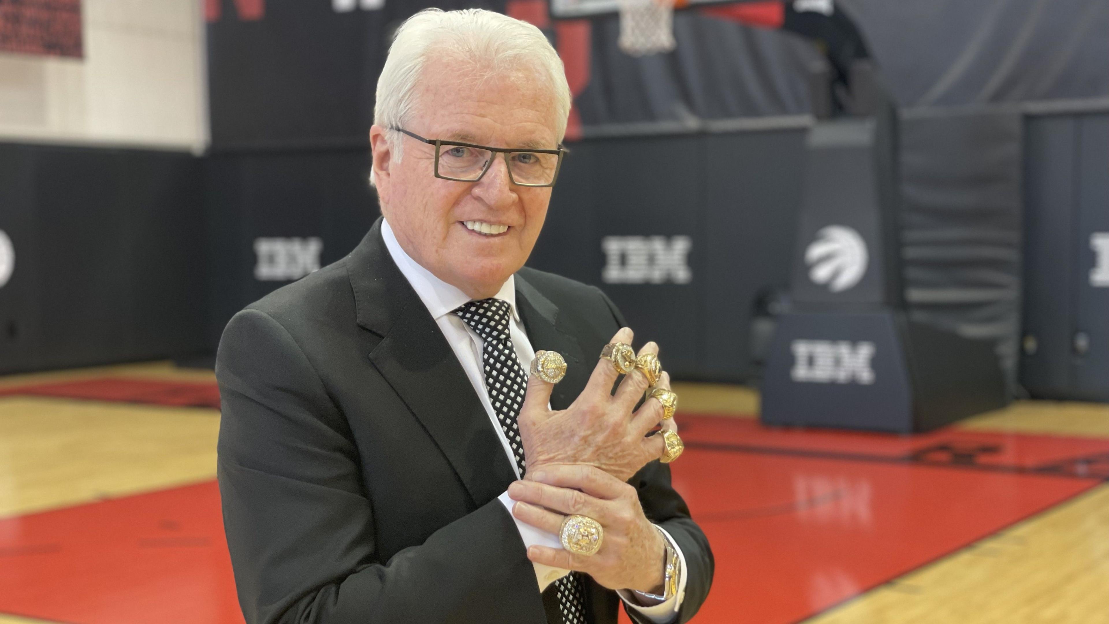 Alex McKechnie wearing his six NBA championship rings
