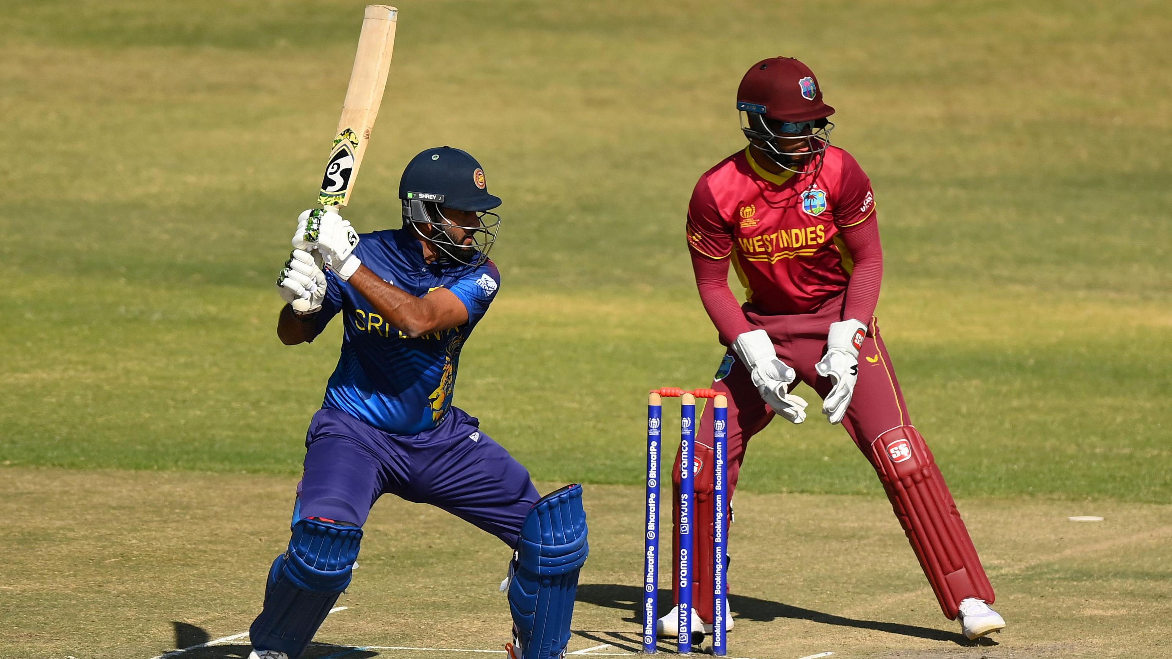 Sri Lanka batter Dimuth Karunaratne hits out, watched by West Indies wicketkeeper Shai Hope, during an ODI in 2023