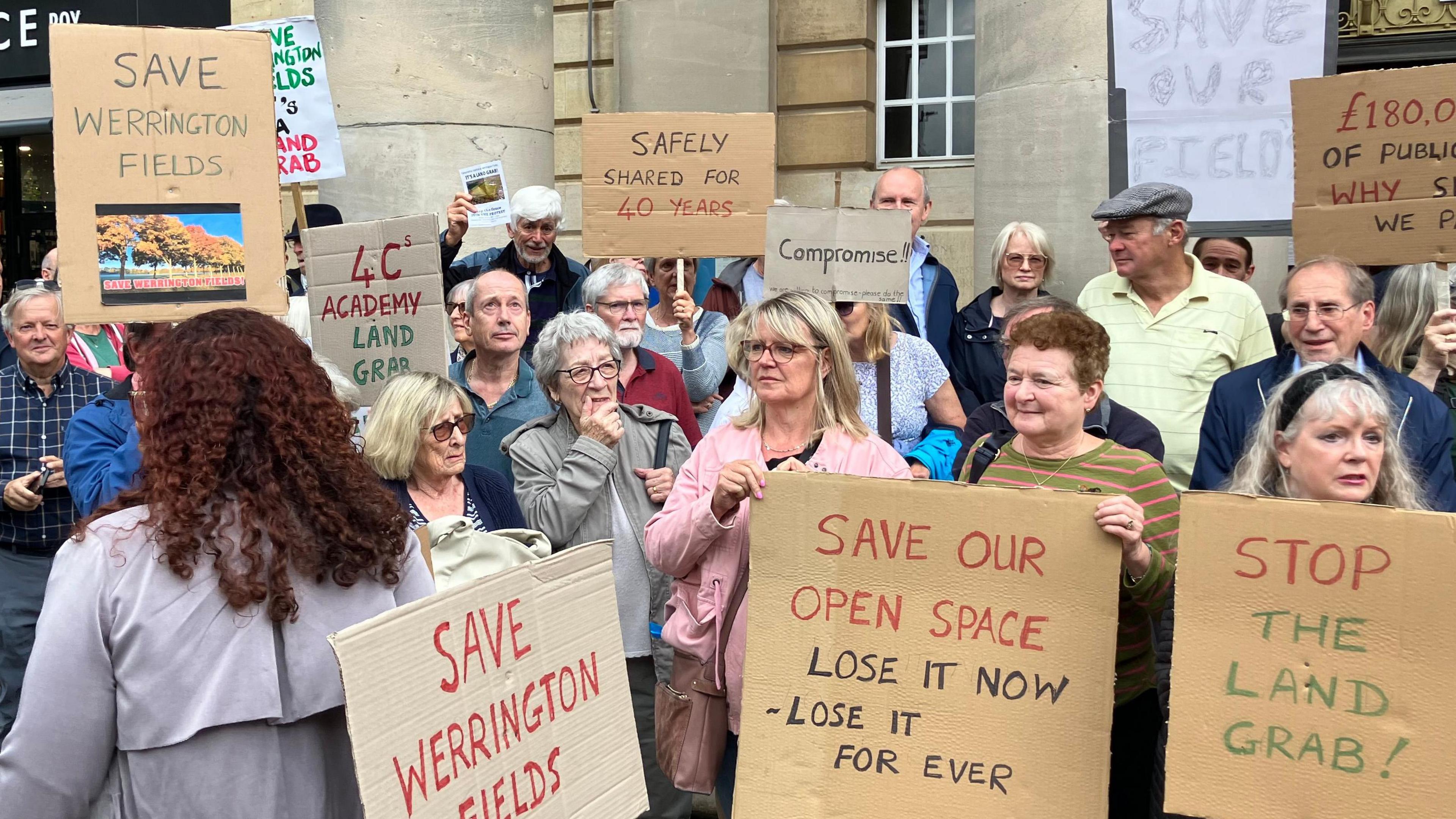 Residents holding placards that read "Save Werrington Fields"