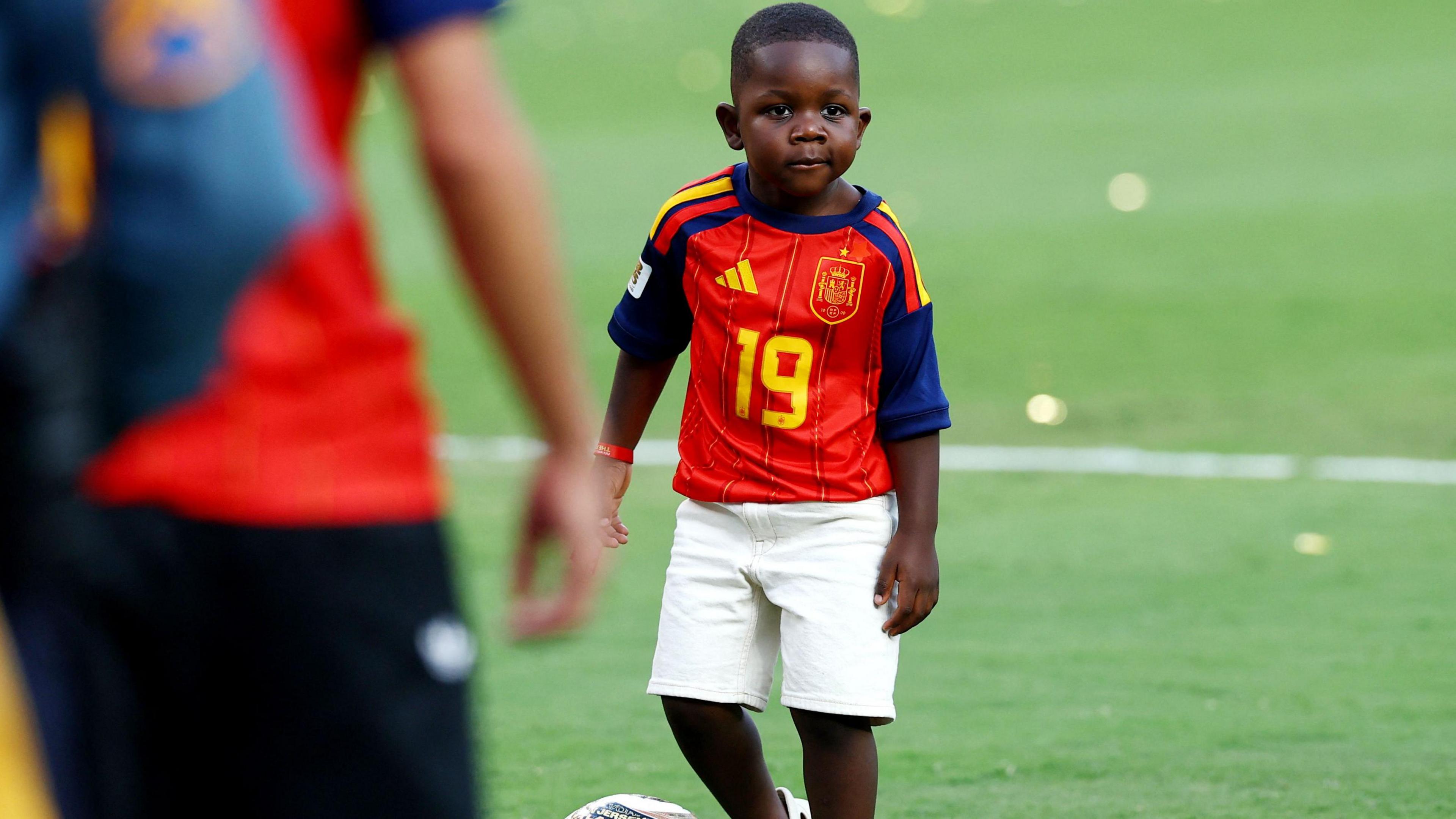 Spain's Lamine Yamal's brother Keyne plays football on the pitch after Spain won the World Cup