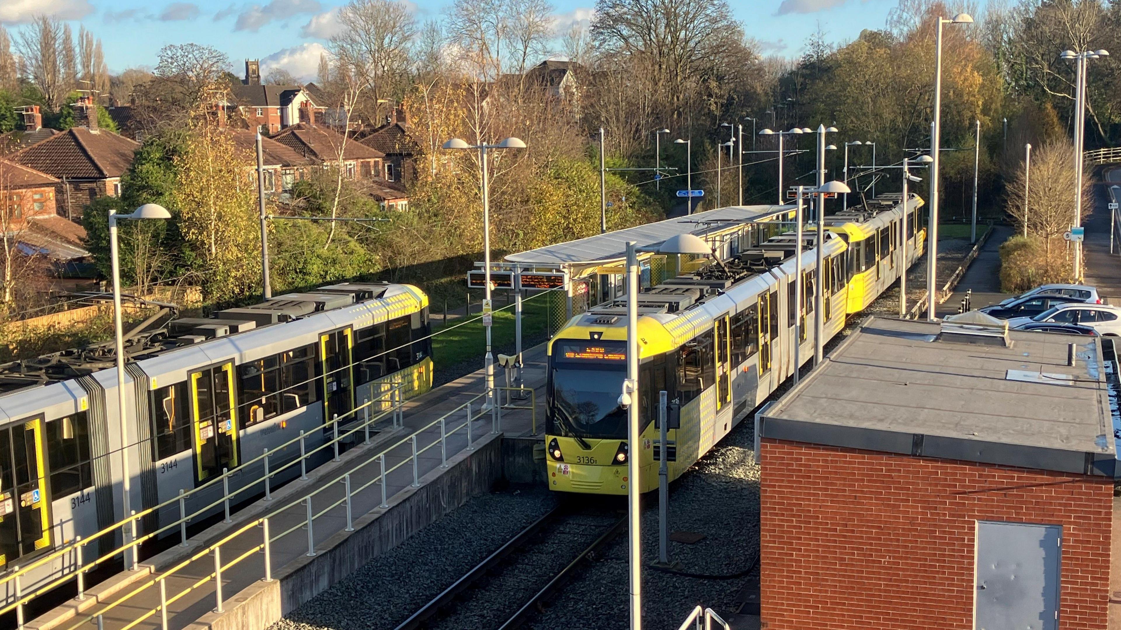 Picture of two trams at the East Didsbury Metrolink stop in Parrs Wood