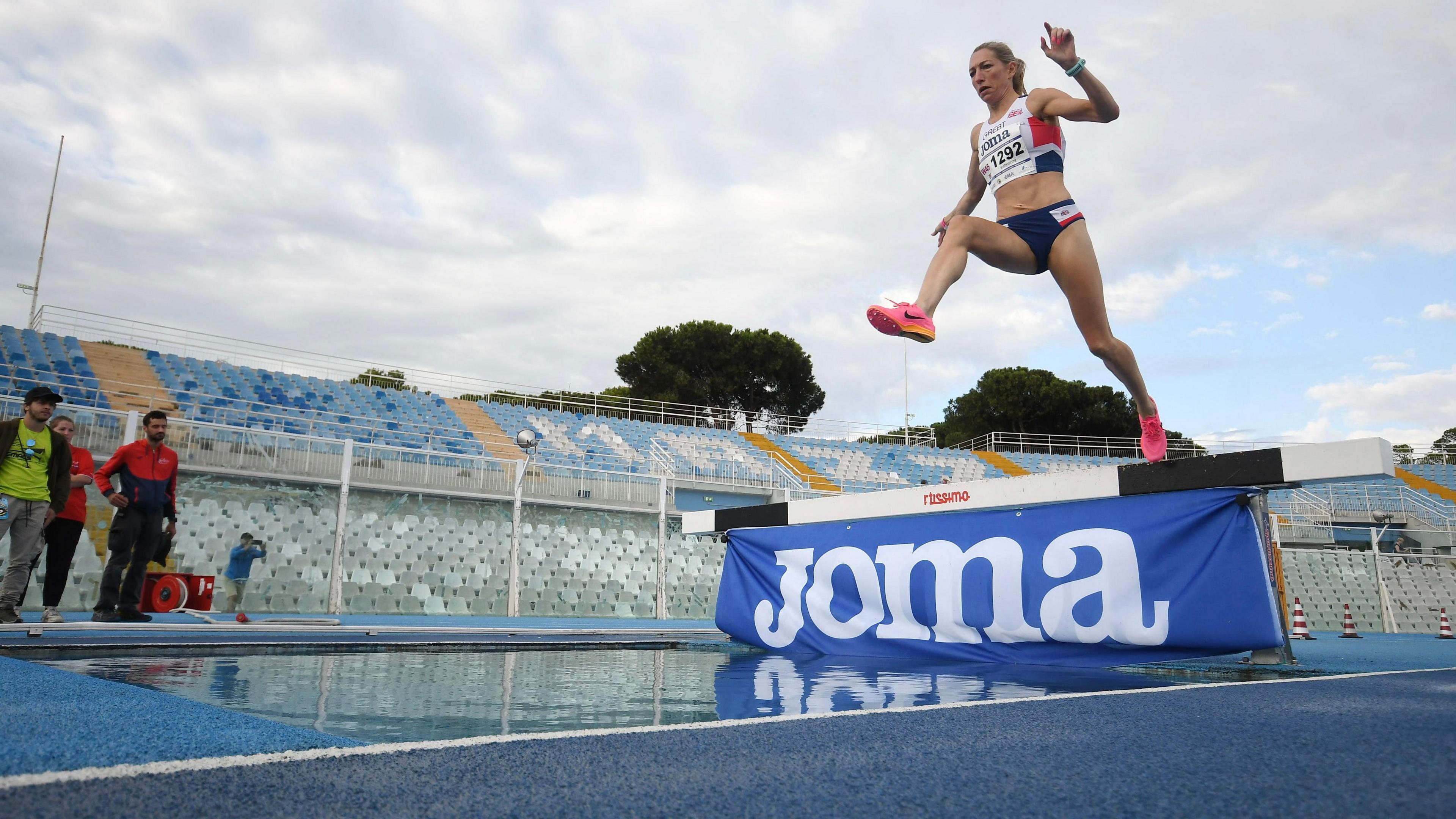 A woman jumps over water