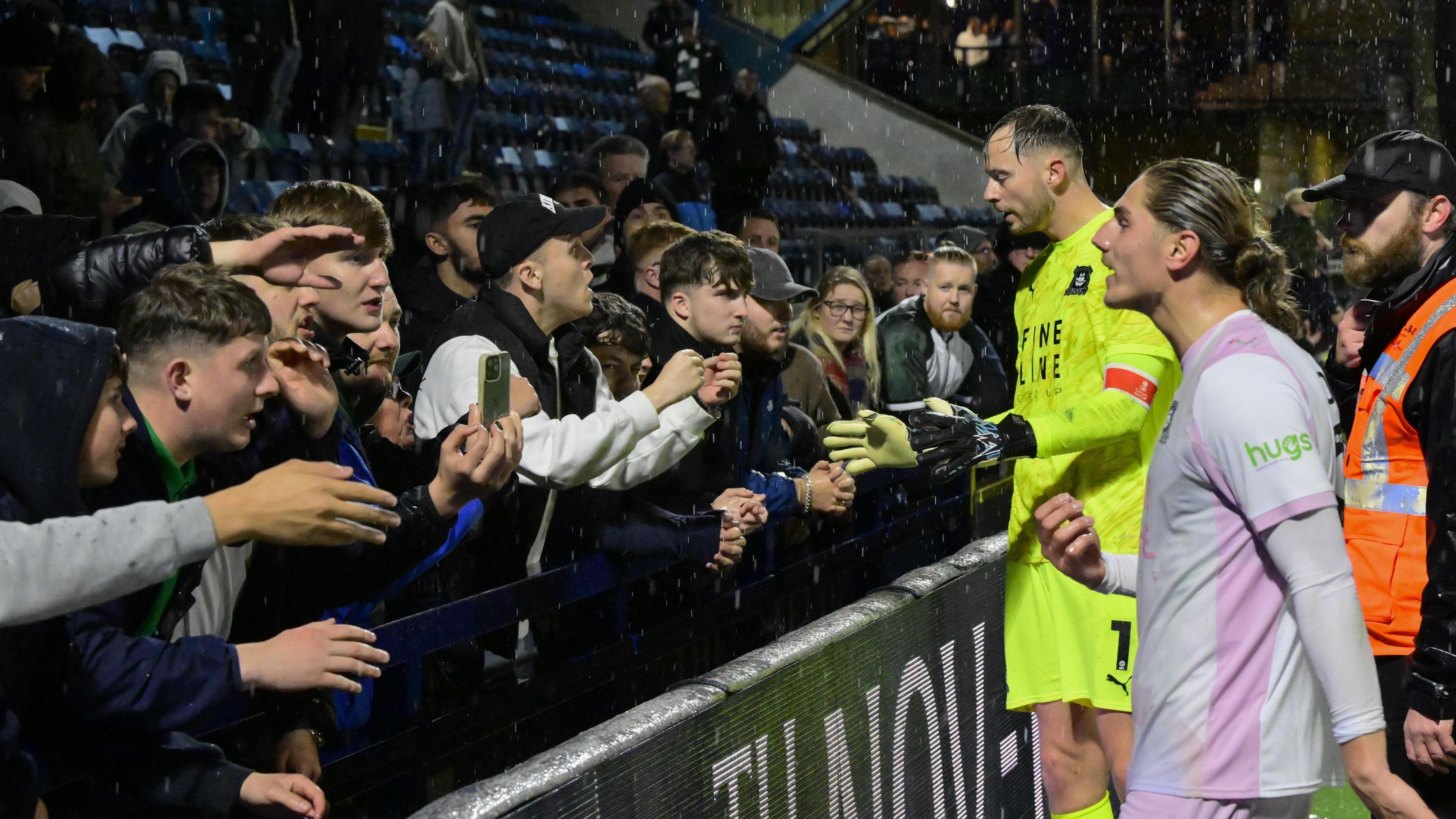 Plymouth Argyle fans make their unhappiness known to goalkeeper Conor Hazard and striker Lorent Tolaj after the game