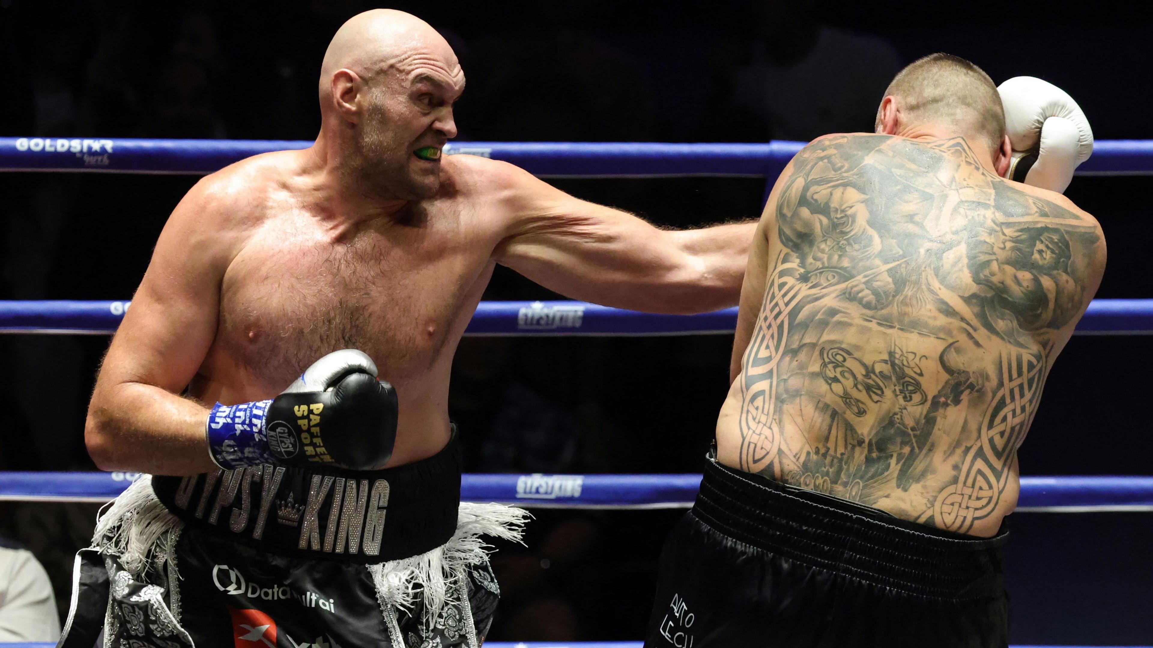 Tyson Fury lands a punch on Mariusz Wach
