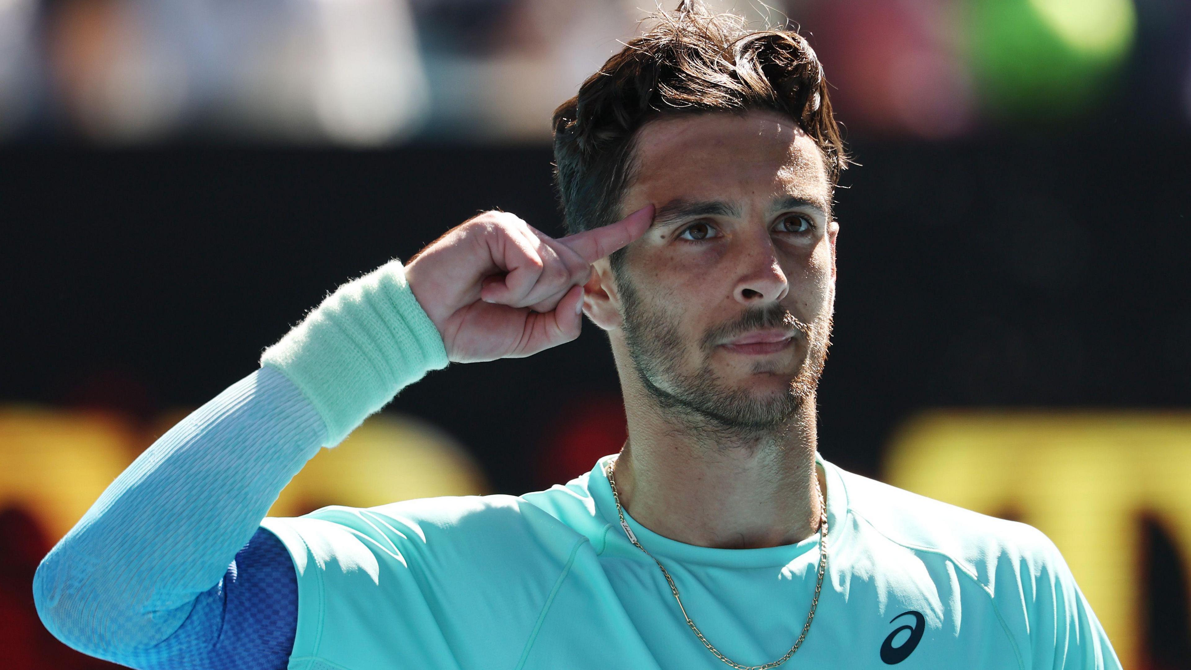 Lorenzo Musetti points to his head