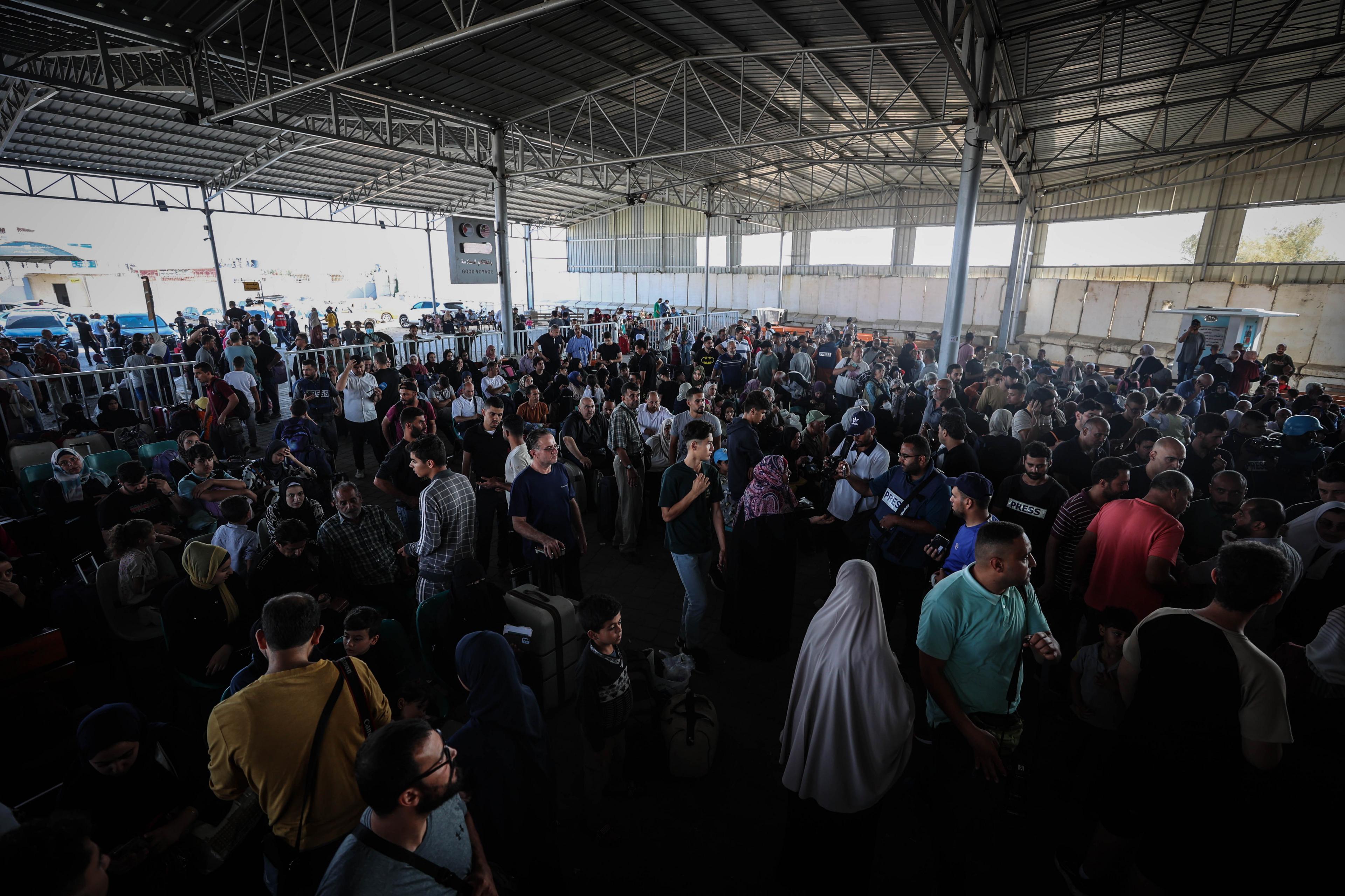 Large crowd of Palestinians with foreign passports waiting to cross into Egypt at the Rafah Border Gate in Rafah