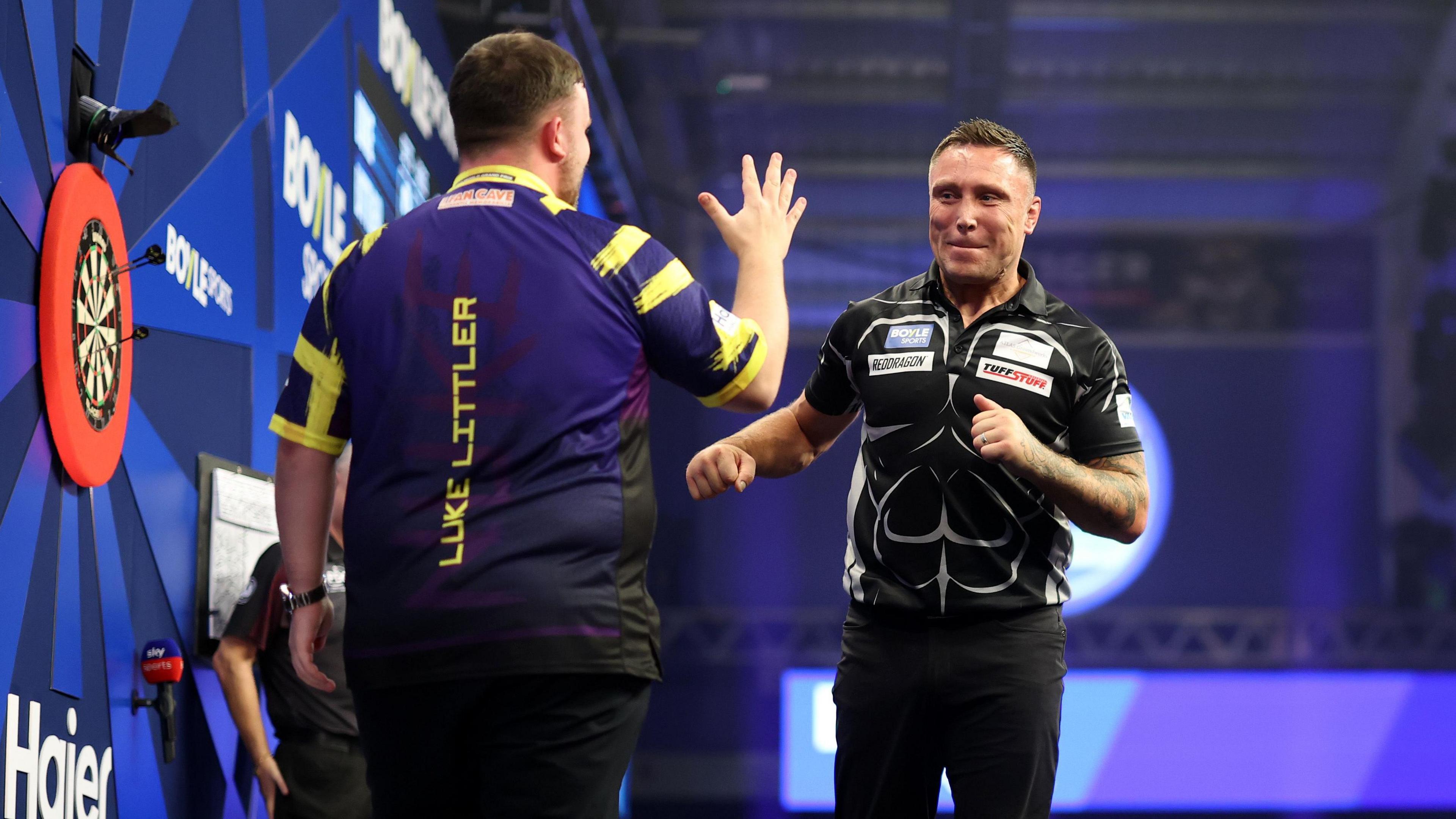 Gerwyn Price and Luke Littler get set to embrace after their quarter-final