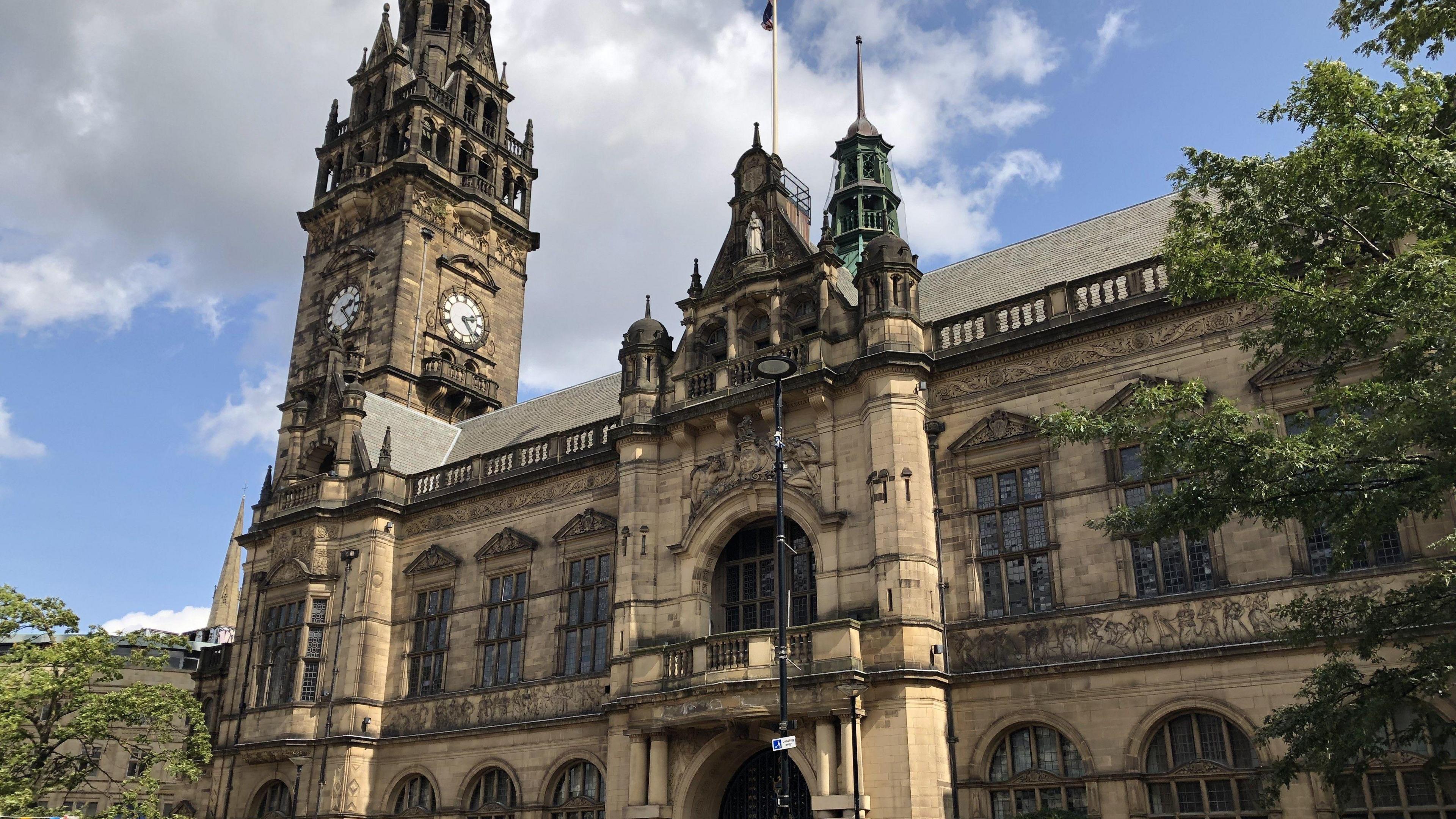 Sheffield's town hall has a clock tower, arched windows and a balcony. It's an ornate Victorian building.