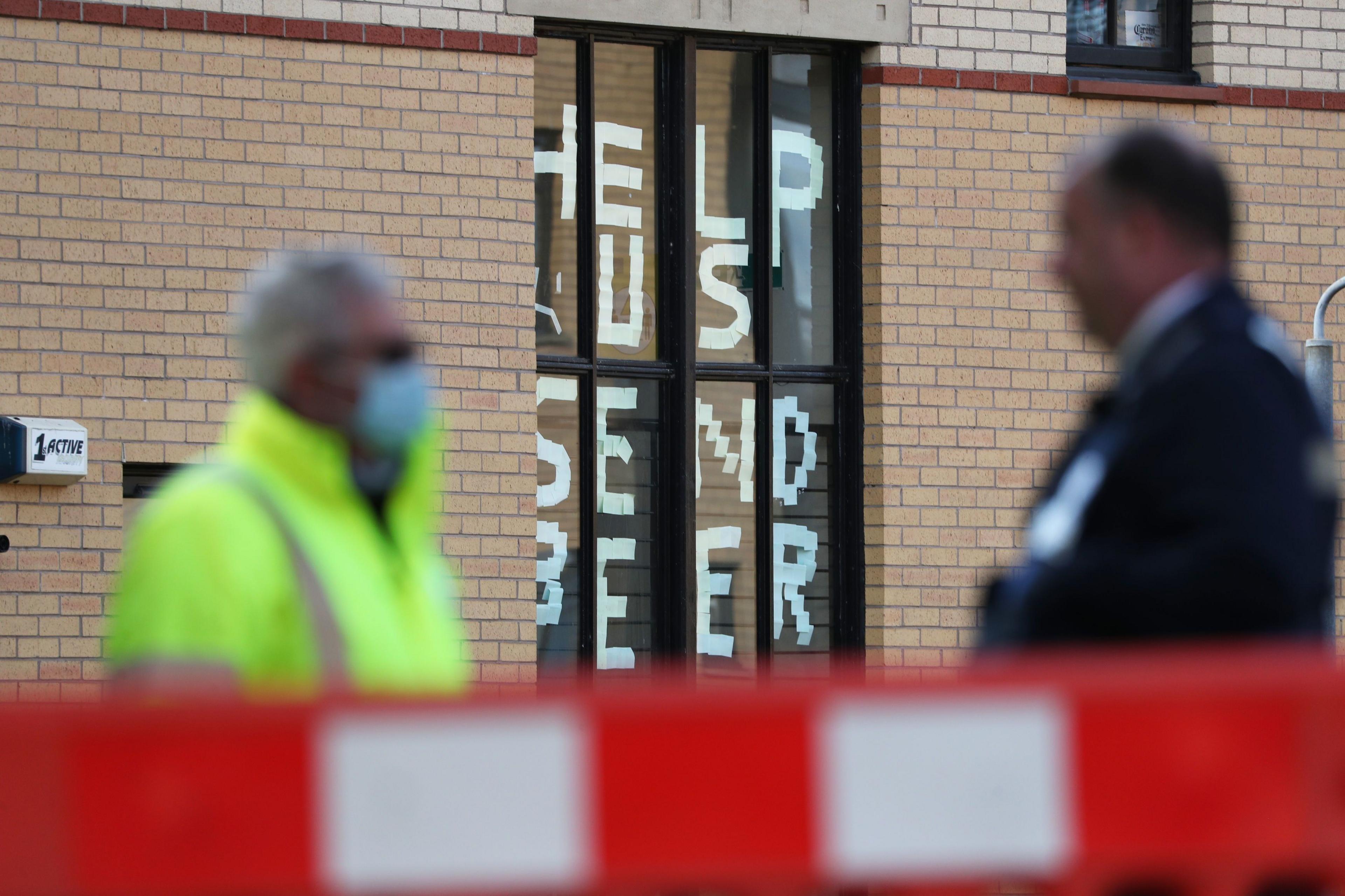 A sign saying "help us, send beer" in a window at Murano Street Student Village in Glasgow, where Glasgow University students were being tested at a pop up Covid test centre in September, 2020