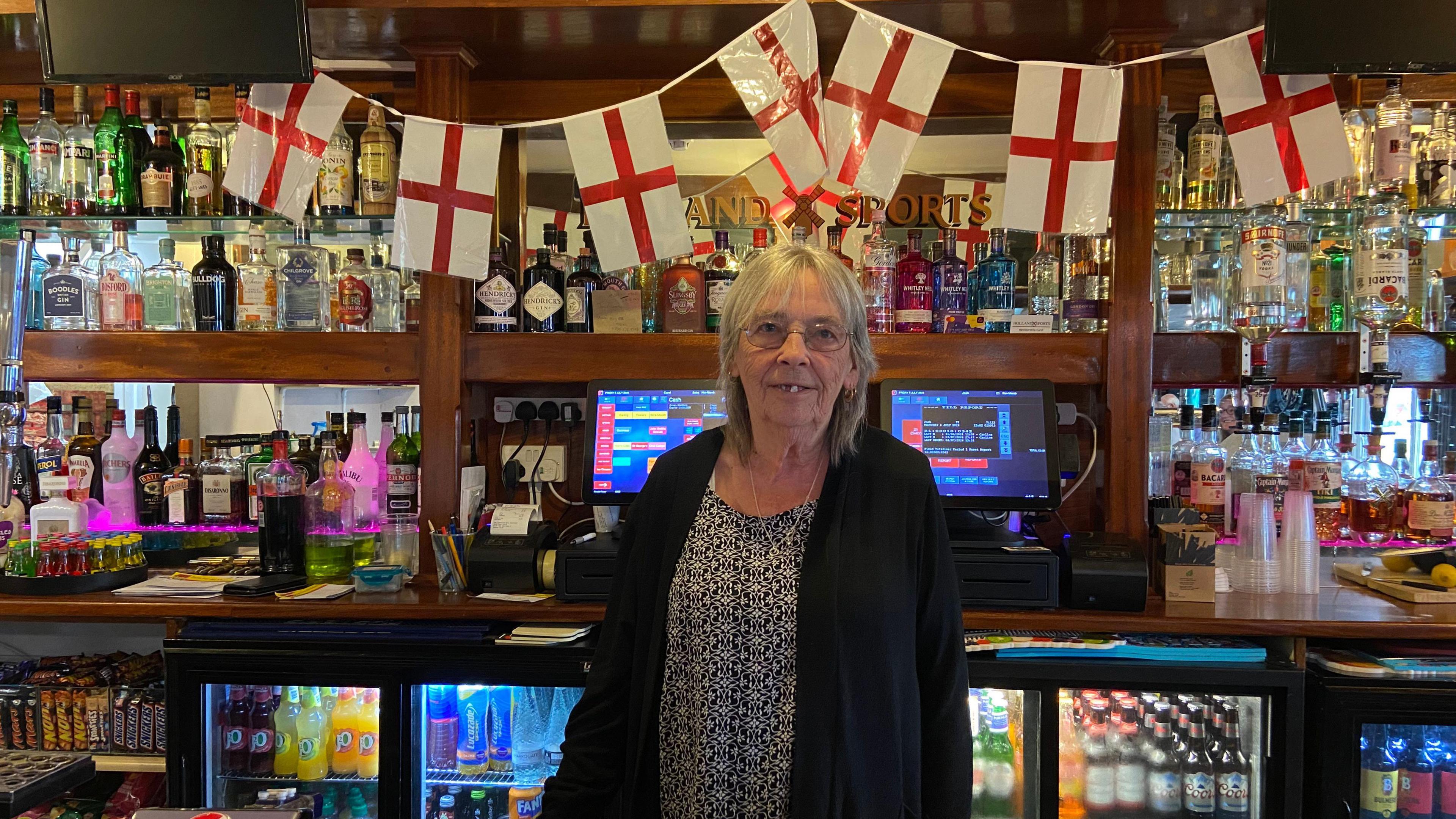 Carol Coomber behind the bar in the social club