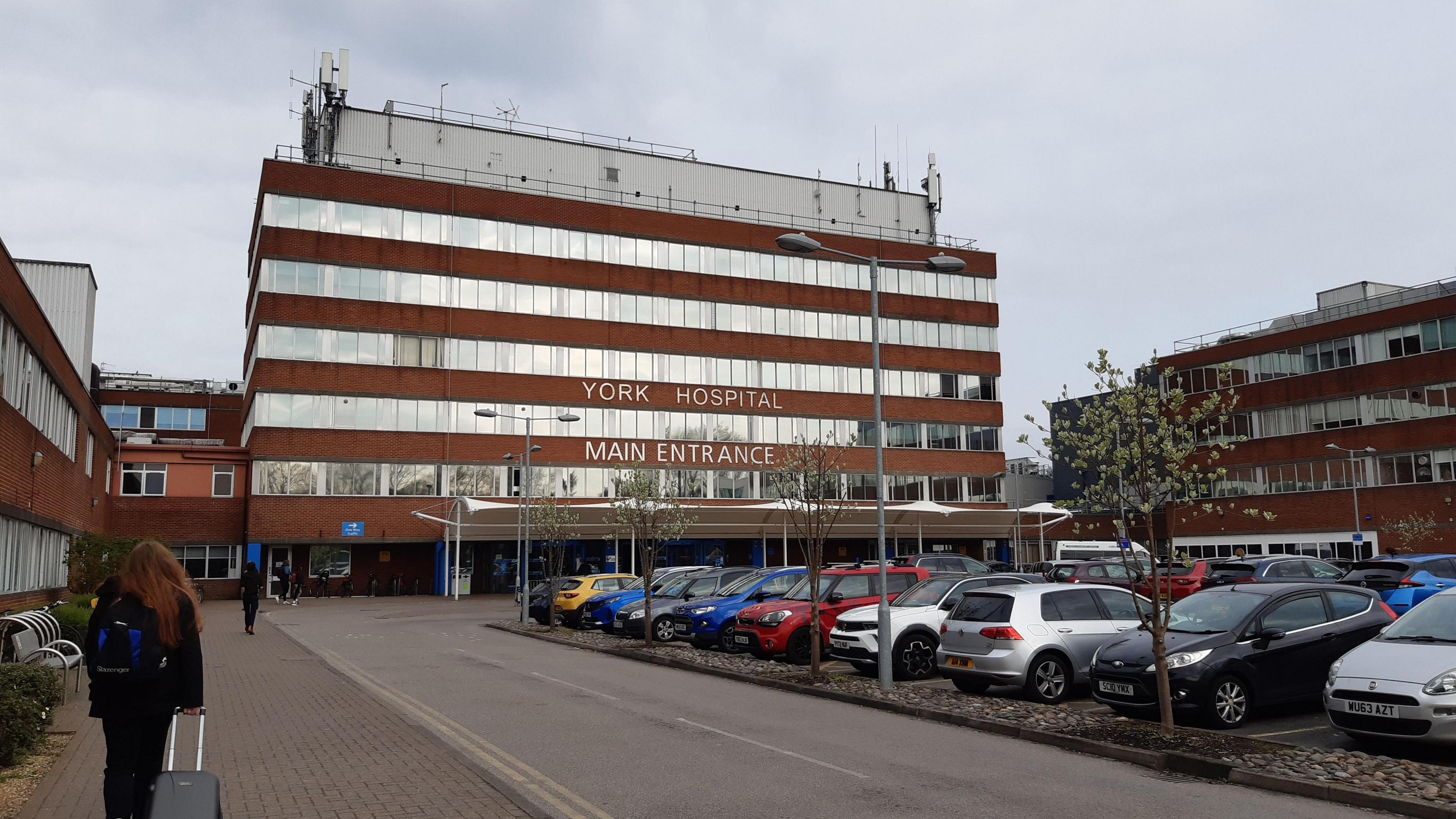 York Hospital, a large six storey building, main entrance and car park.