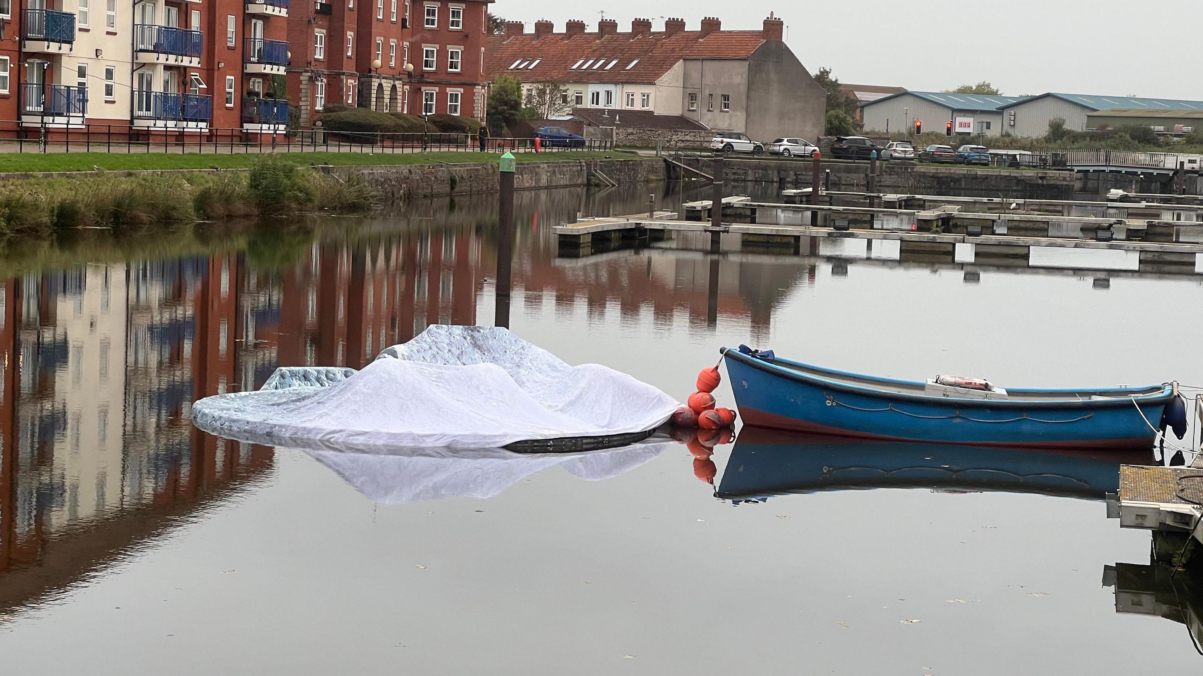 Image shows the Fallen Moon artwork deflated on the service of the water