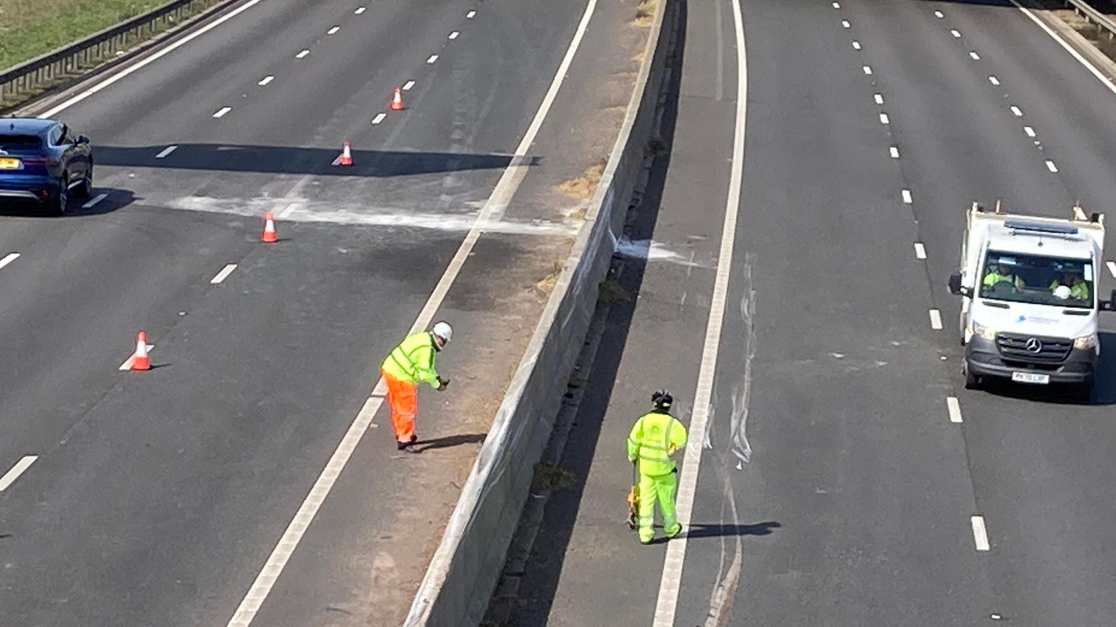 Workers assessing the road