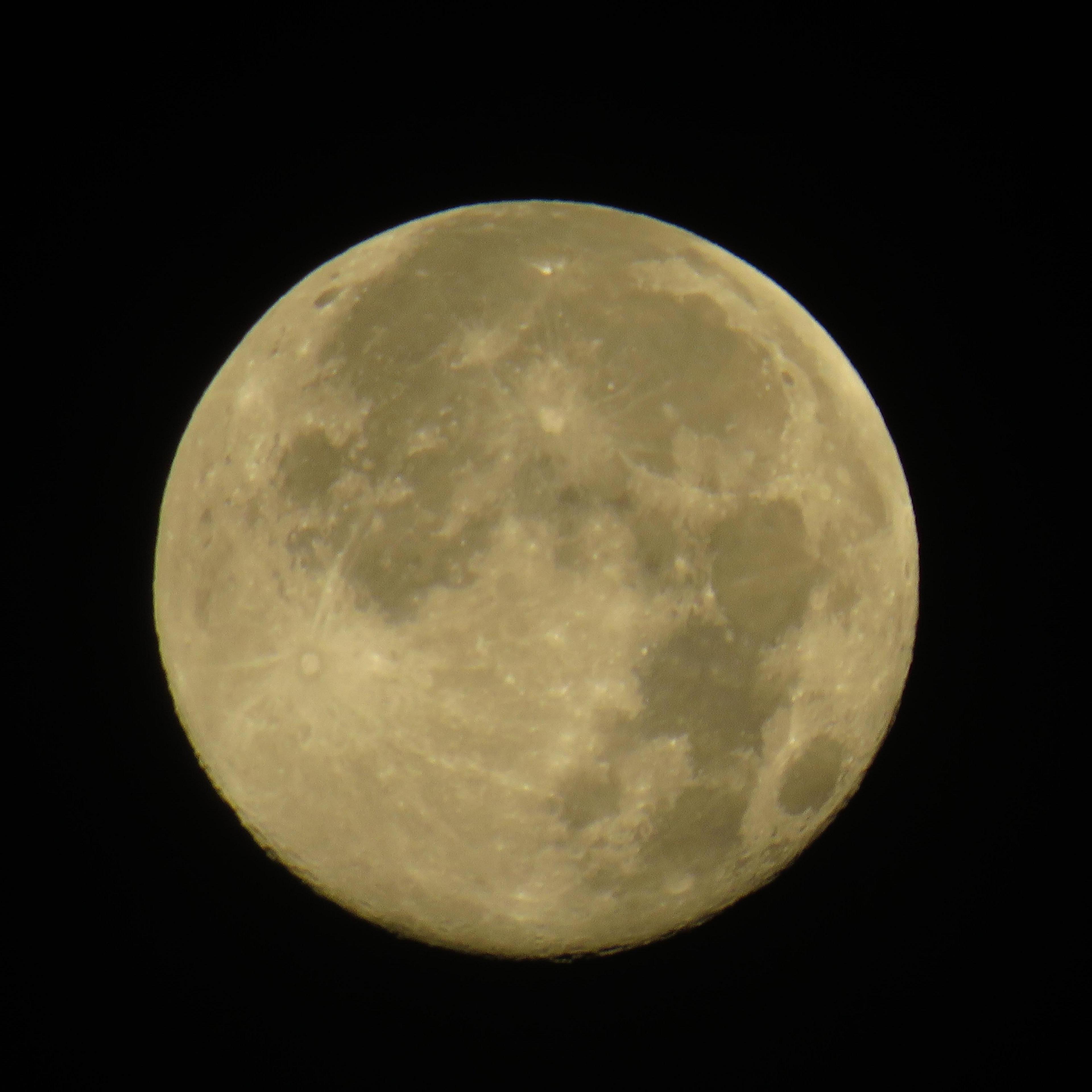 A close up of the moon with craters visible.