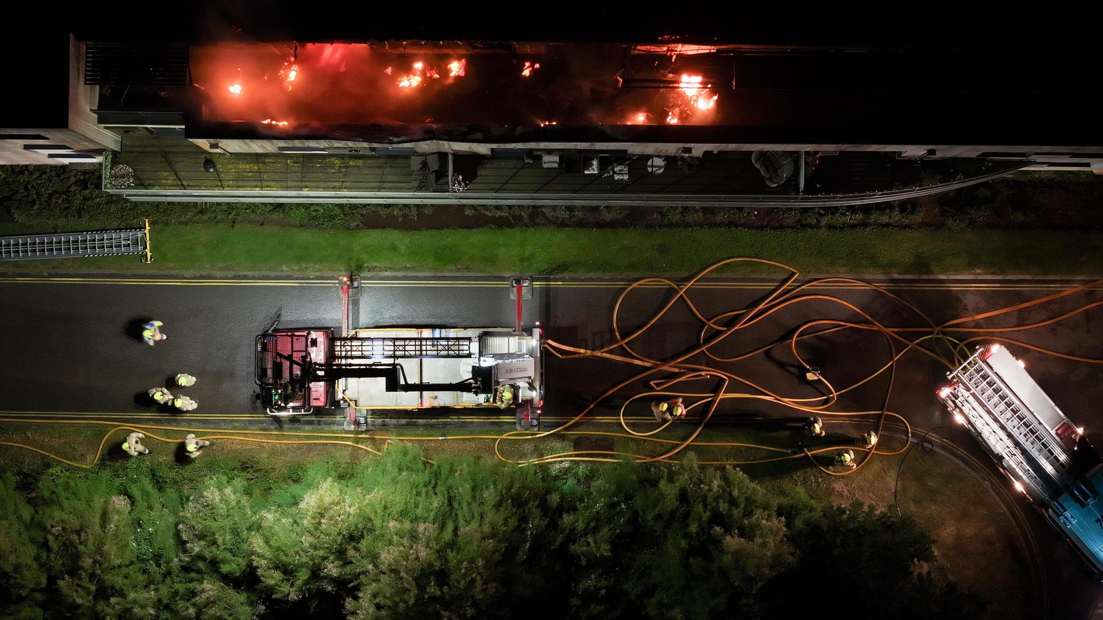 An aerial view of a fire engine and burning block of flats in Goring-by-Sea 