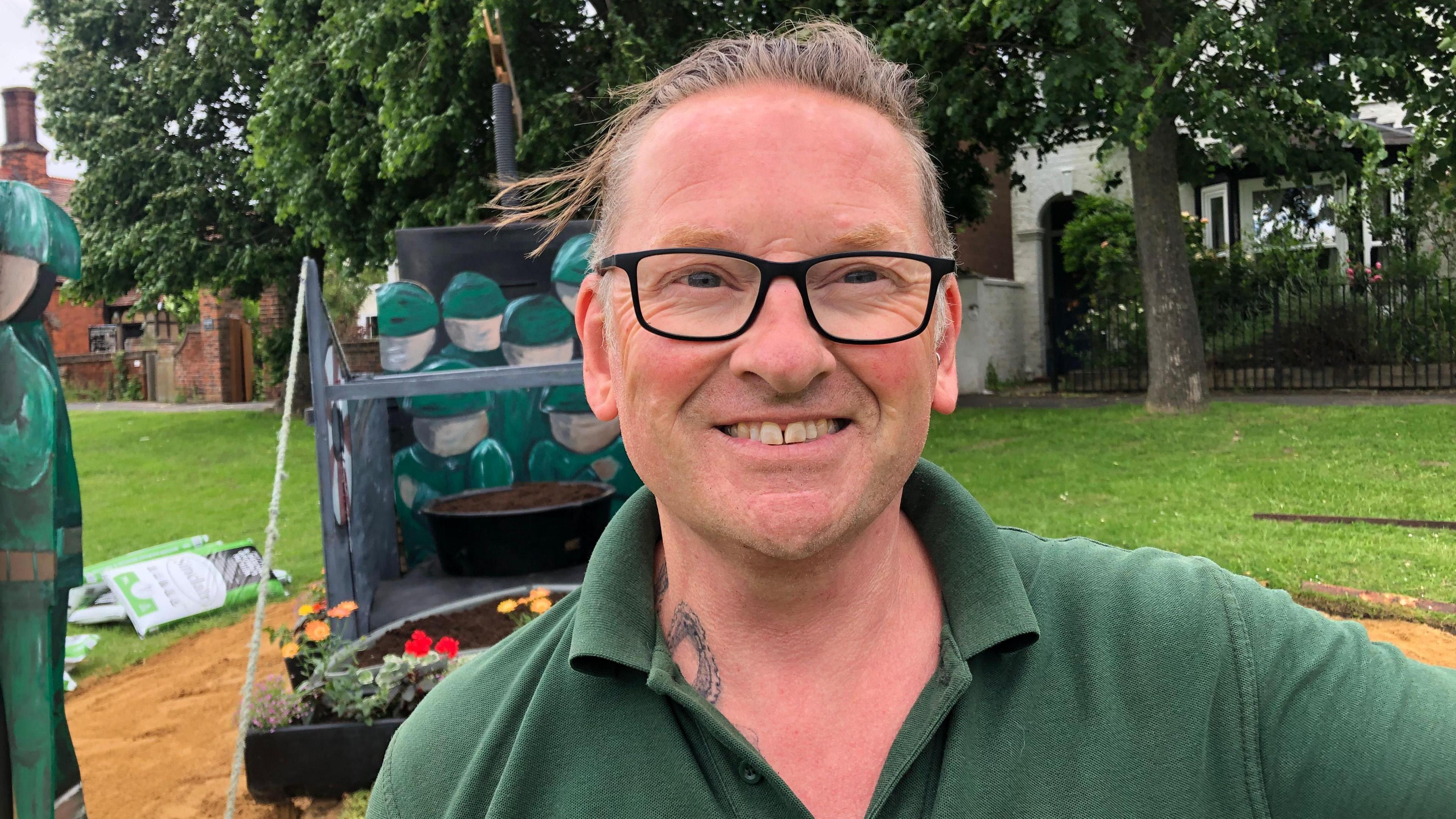 Andrew Buddle from Huntingdon Town Council in front of the landing craft he built