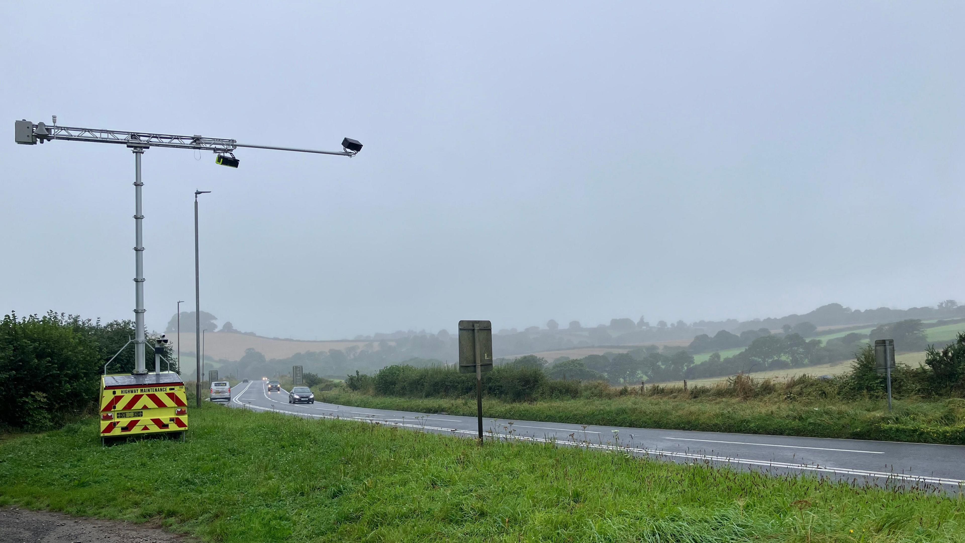 A trailer mounted with AI cameras on the left of the shot, with the A38 on the right side with vehicles on the road 