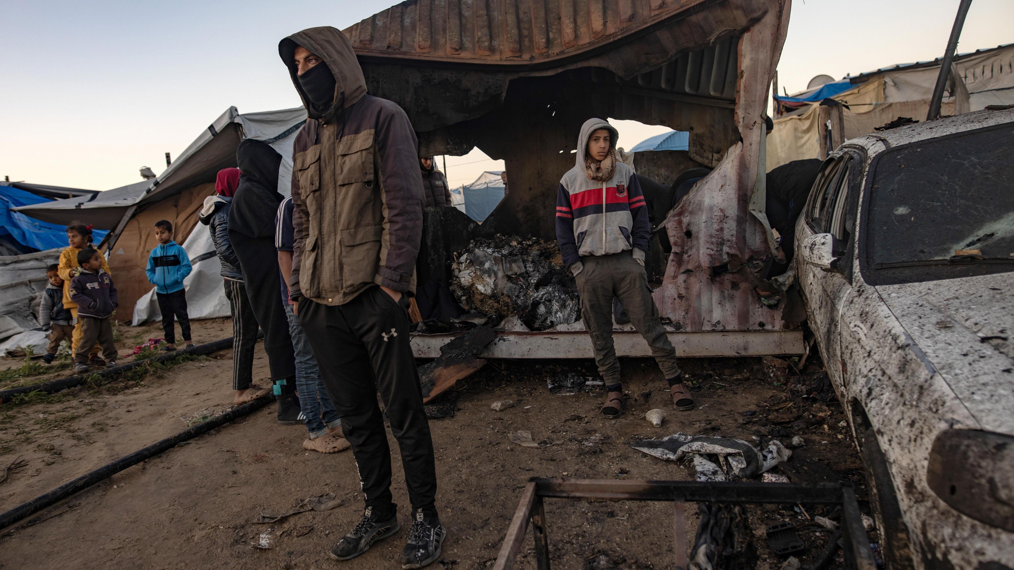 People inspect damage after an Israeli air strike reportedly killed 11 people at a tent camp for displaced families in al-Mawasi, southern Gaza (2 January 2025)