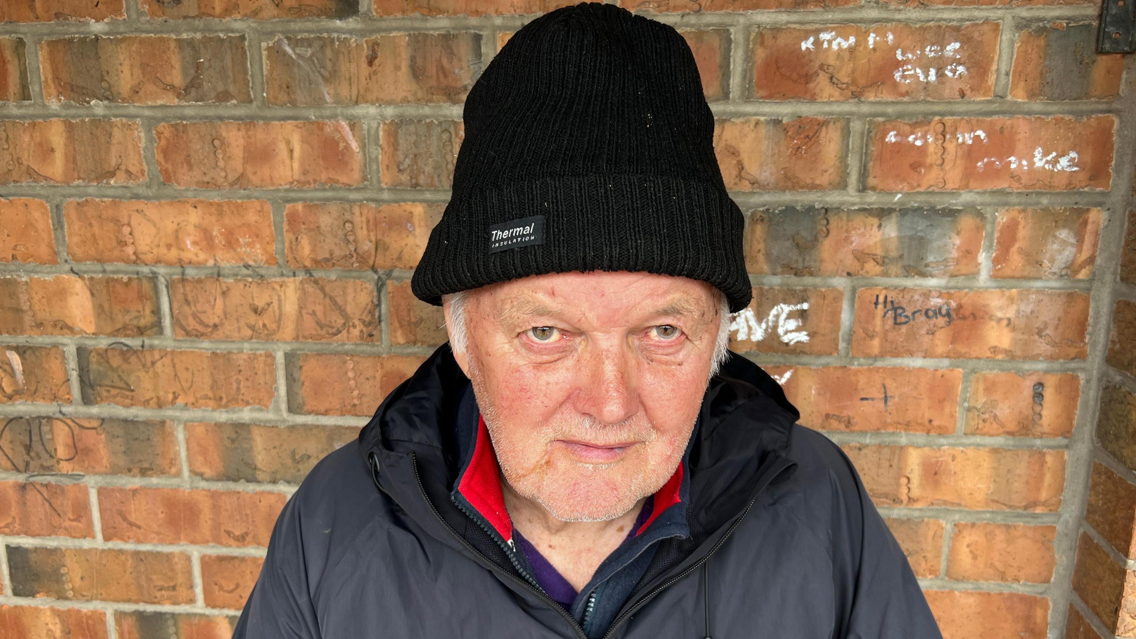 Bus passenger Philip Lawton pictured facing camera in front of a brick wall