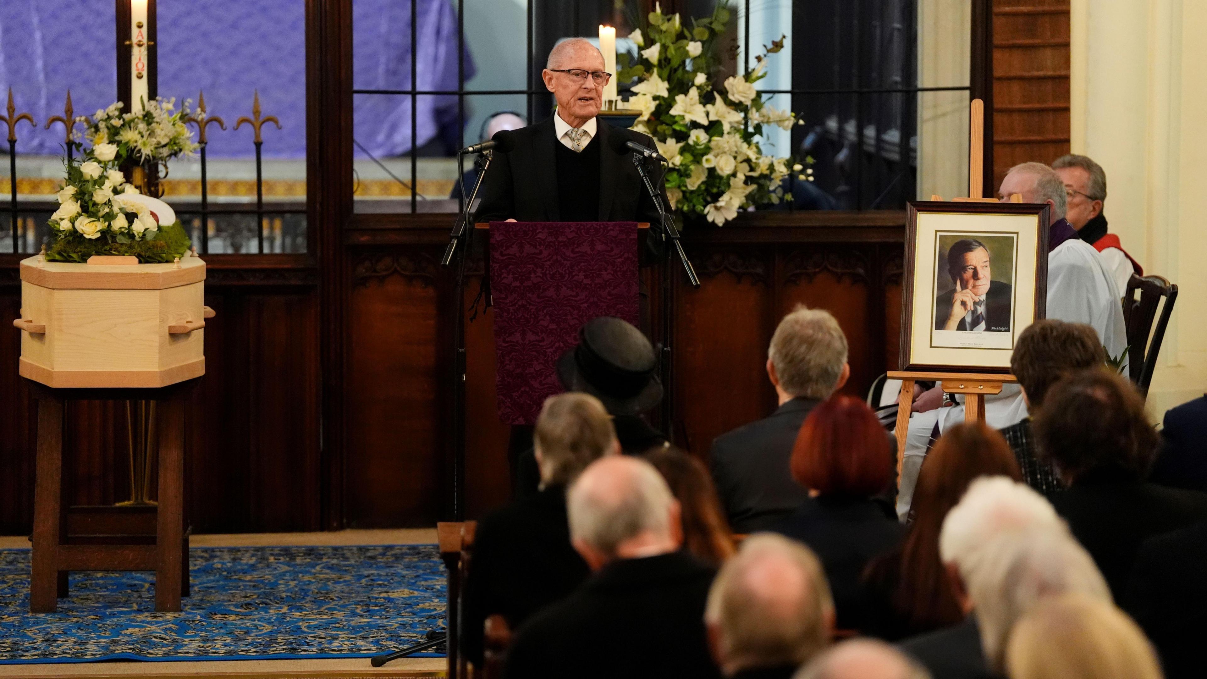 Man speaking at a person's funeral