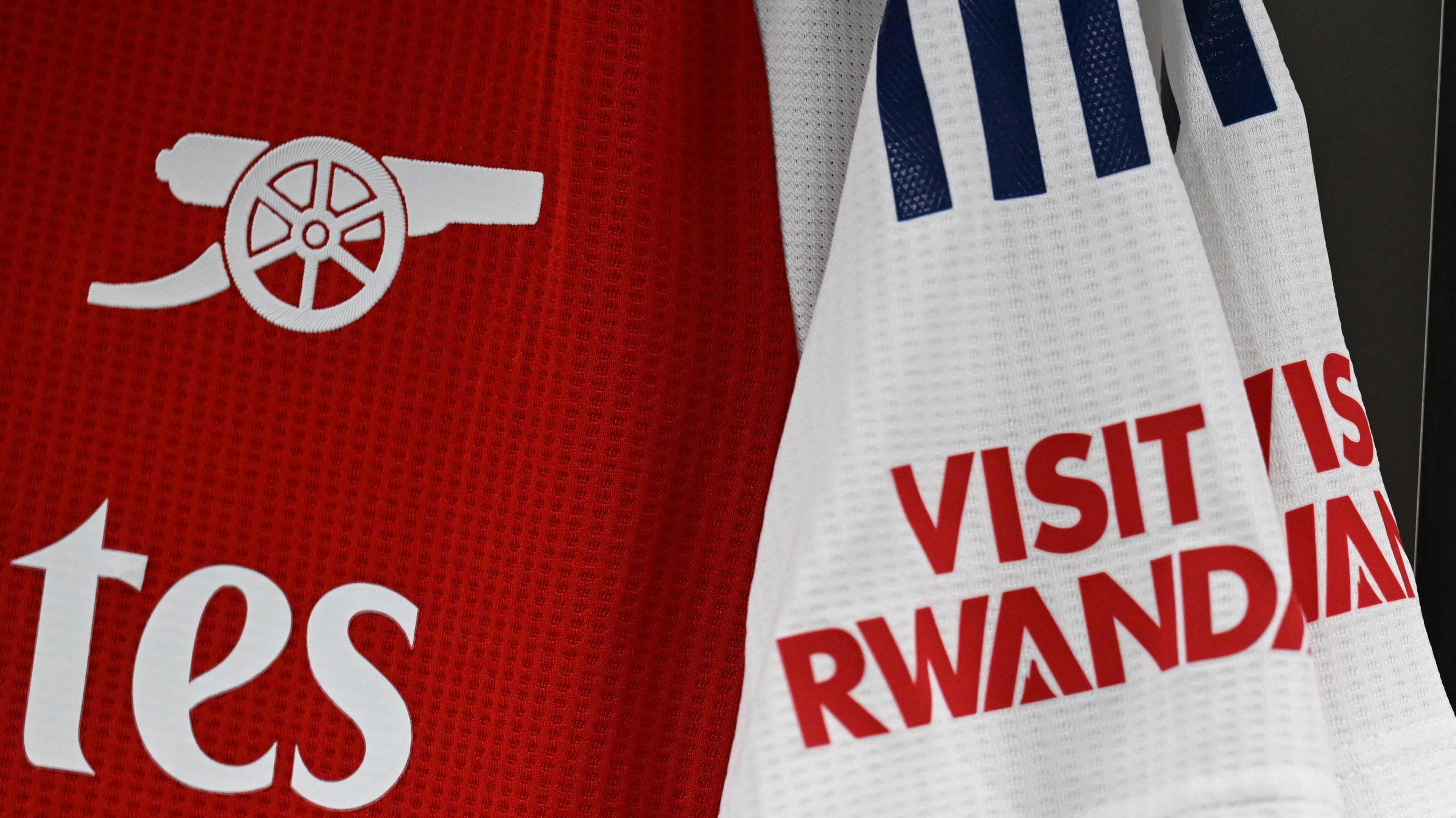 Detail of a red and white Arsenal shirt, with the Visit Rwanda on the sleeve