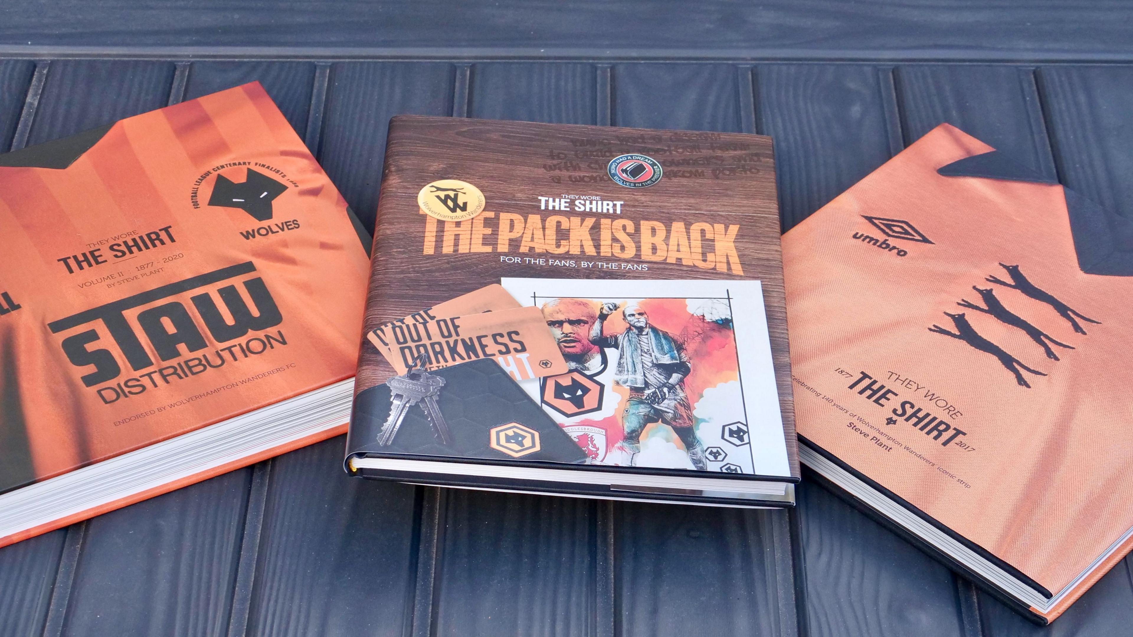 Three hardback books on a table about Wolves football club and its history.