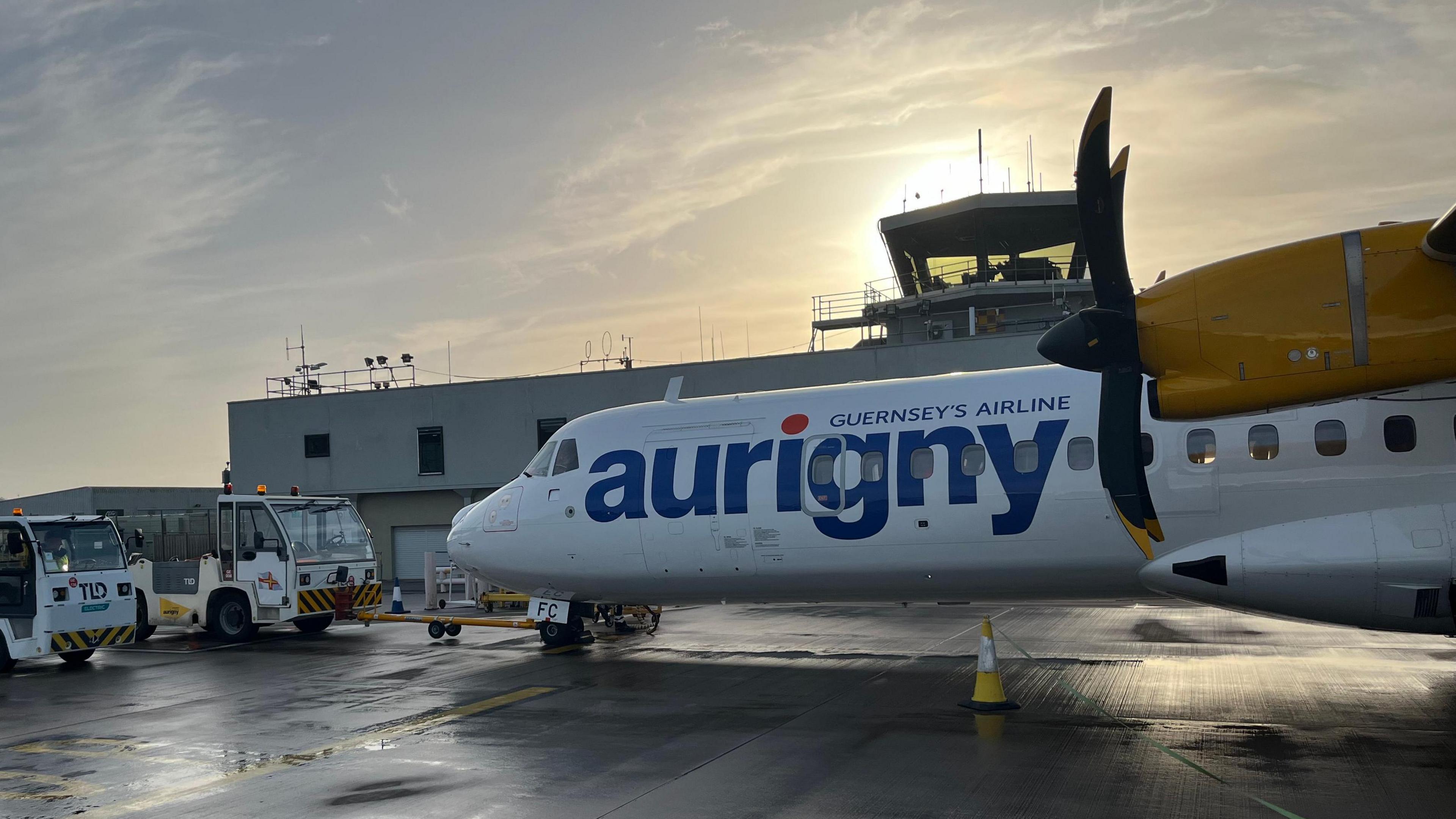 An Aurigny aeroplane at an airport terminal 