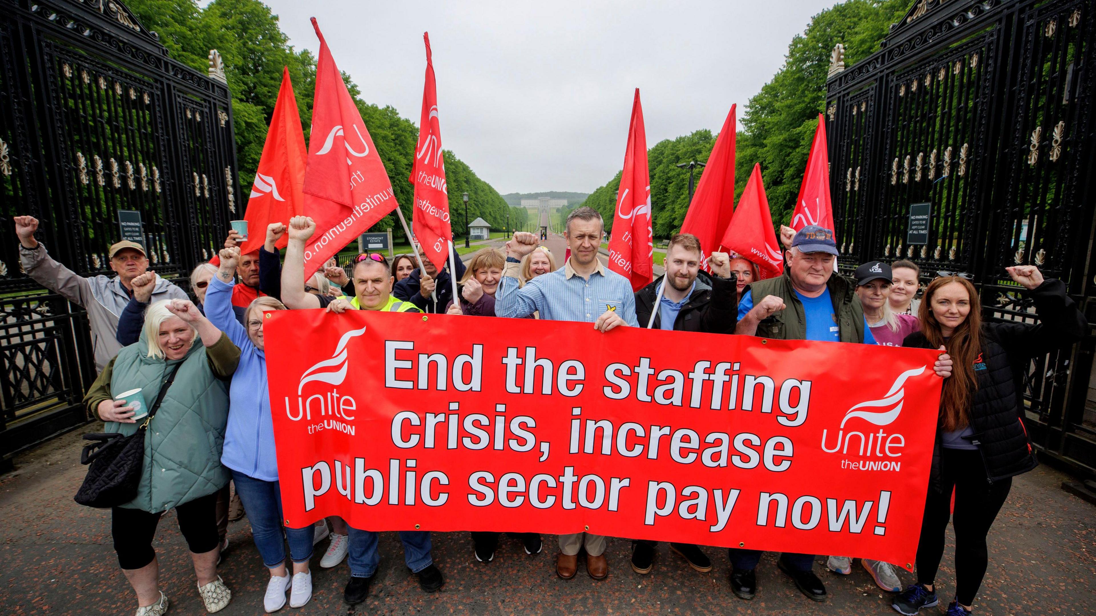 Members and supporters of Unite the union protesting at the gates of Stormont