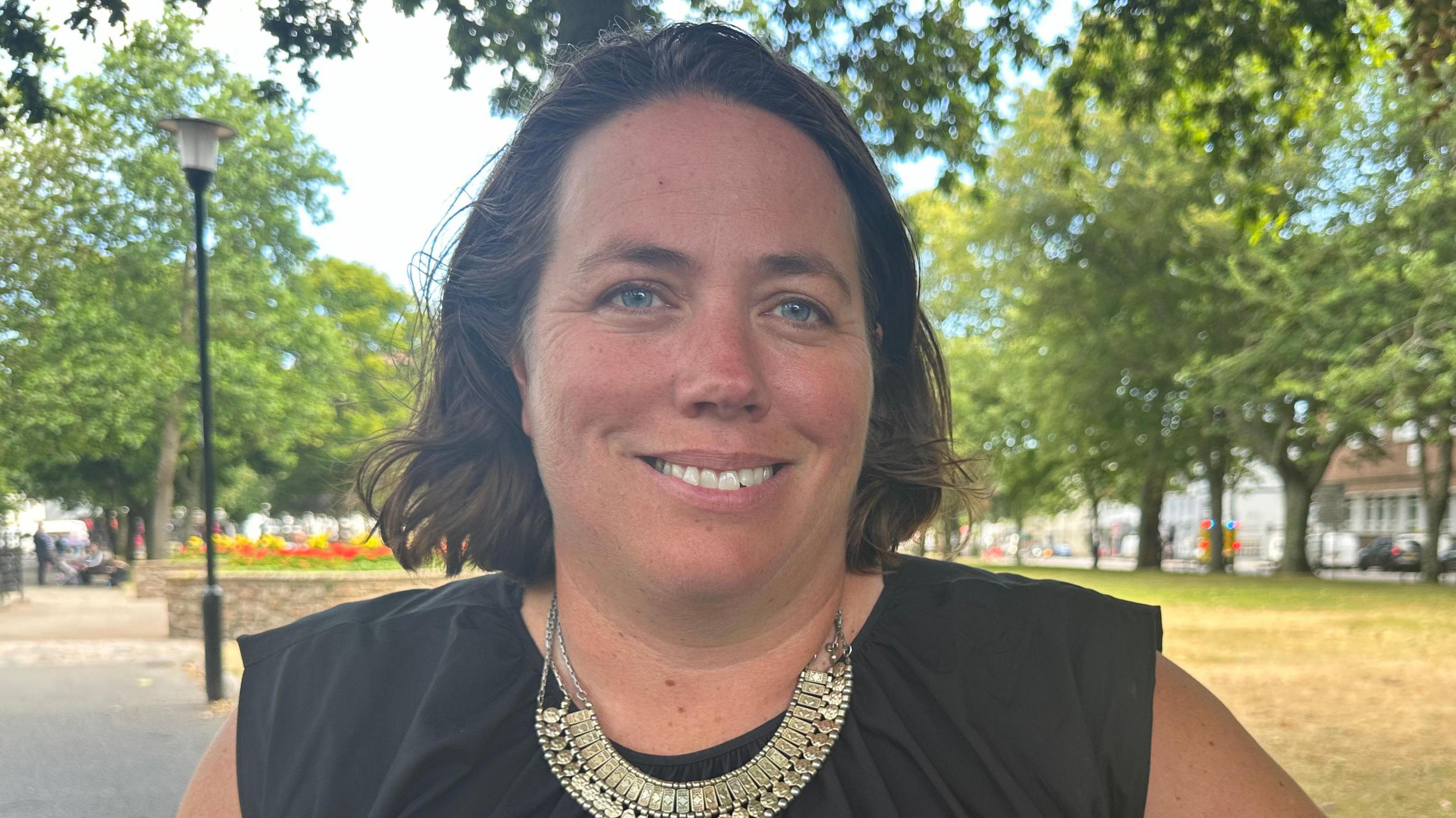 Head and shoulders shot of a woman in a park