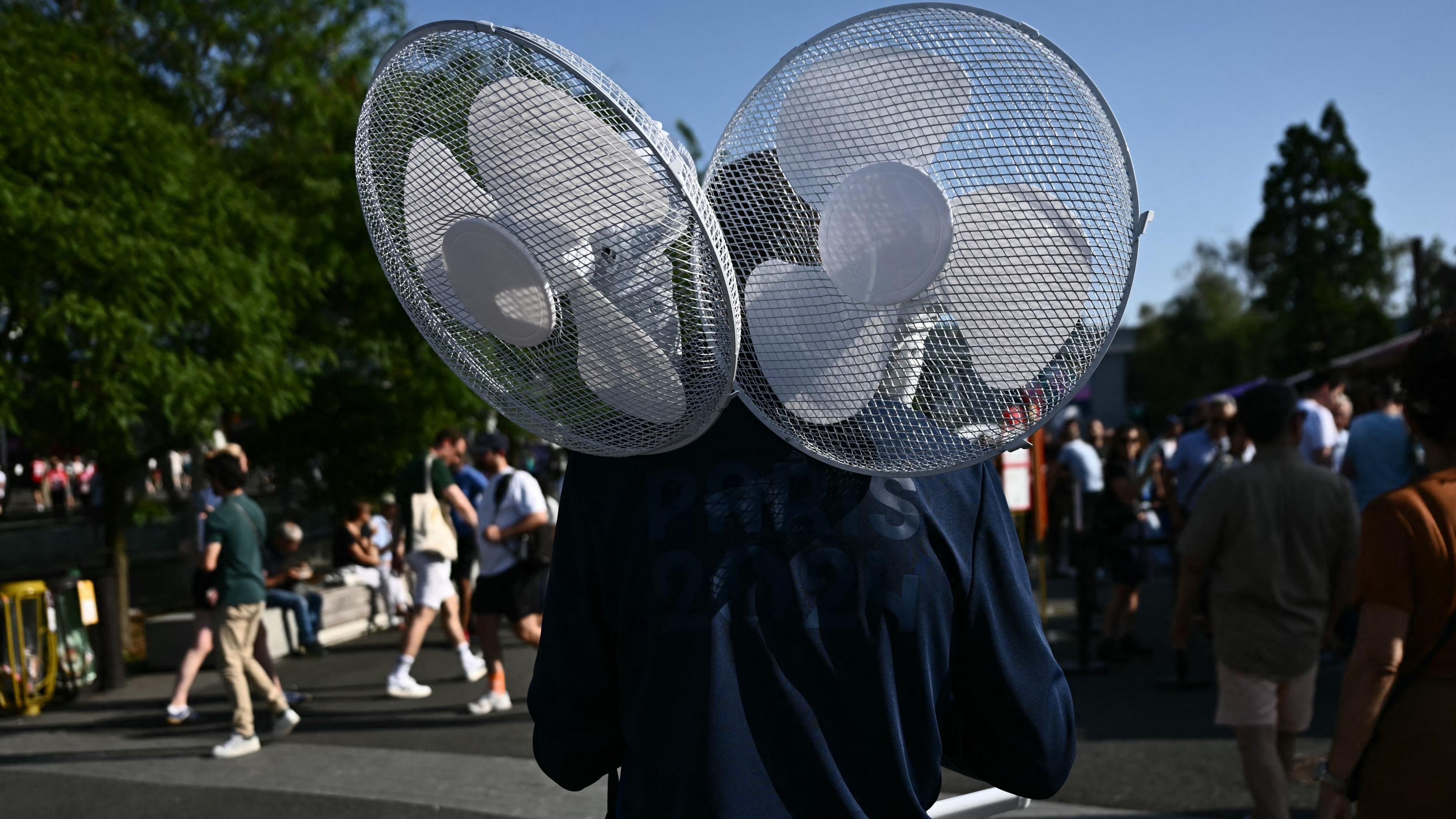 Man carrying fans