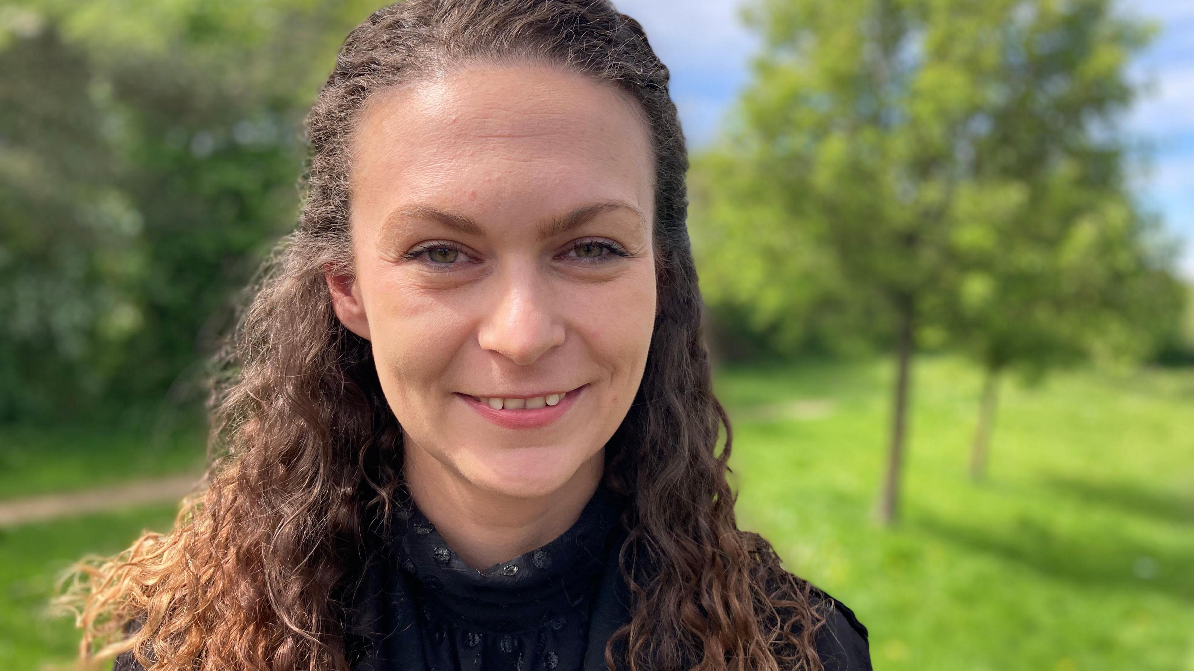 Stanka Adamcova smiles in front of trees