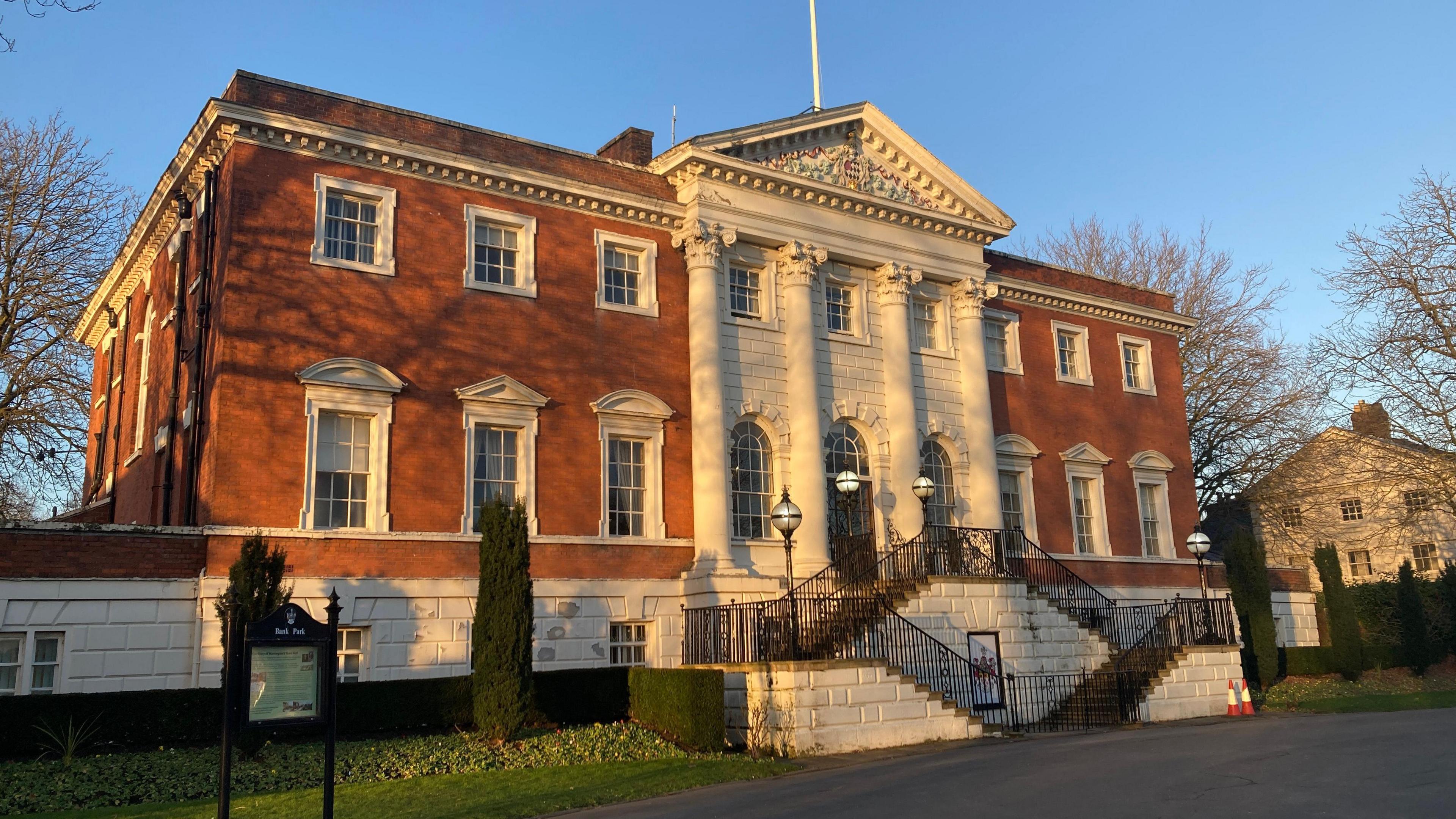 The two-storey, red brick Warrington Town Hall on a sunny day.
