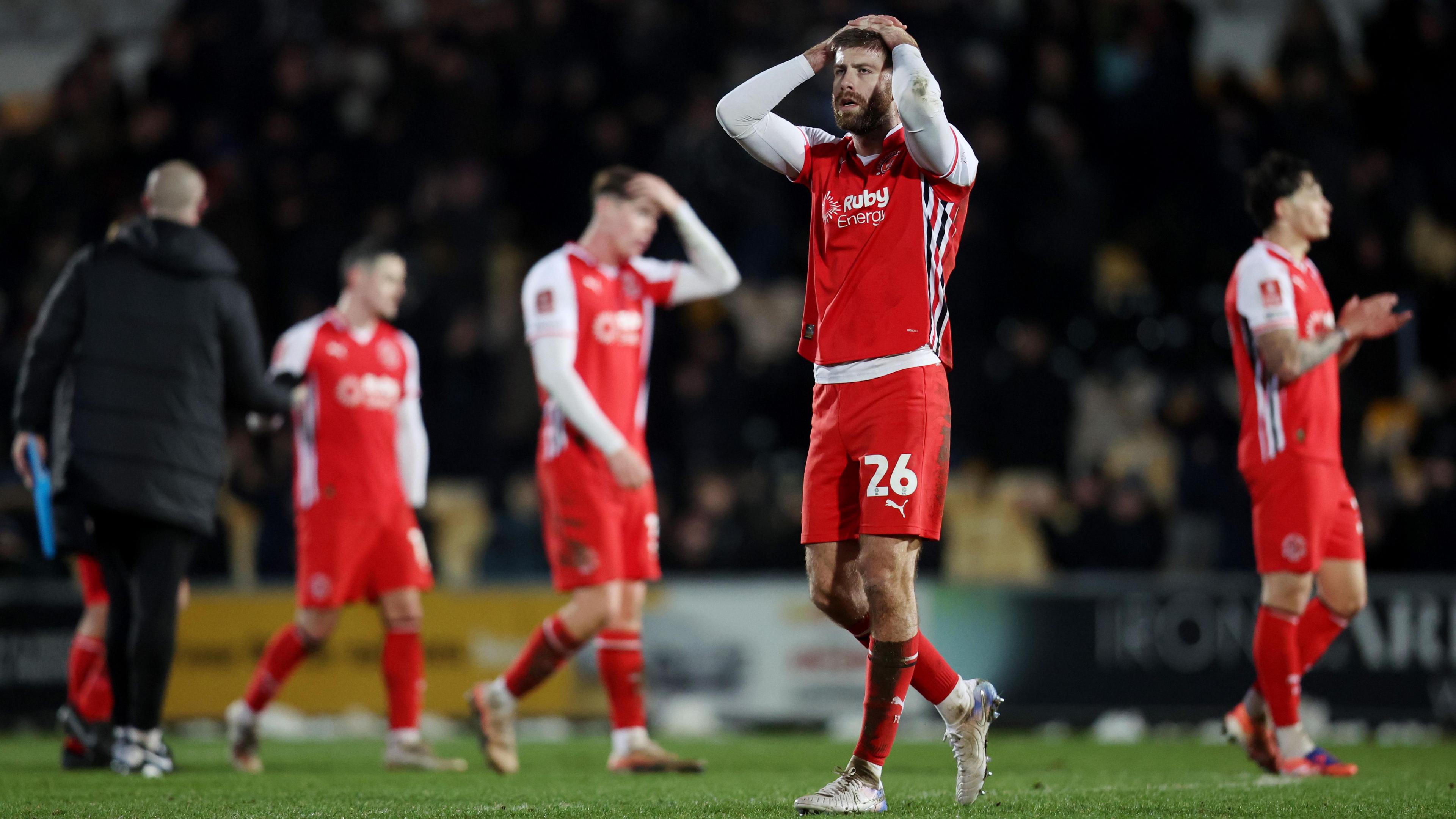 Shaun Rooney of Fleetwood Town holds his head in his hands after full-time in their defeat byPort Vale 
