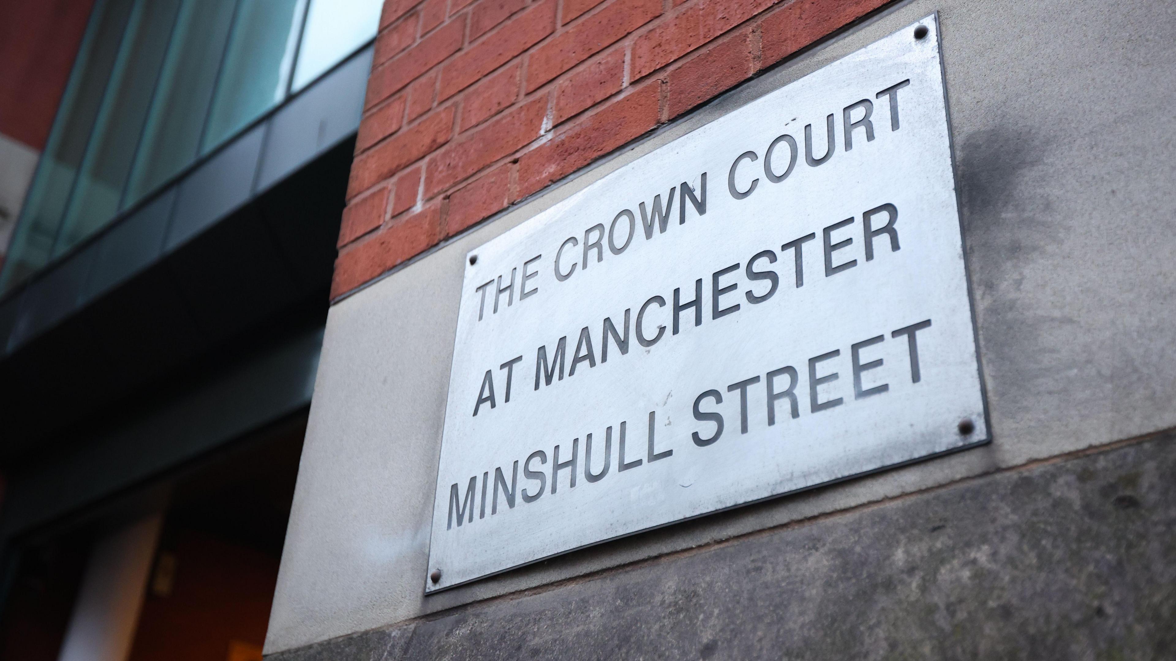 A metal sign attached to the redbrick entrance to Minshull Street Crown Court.