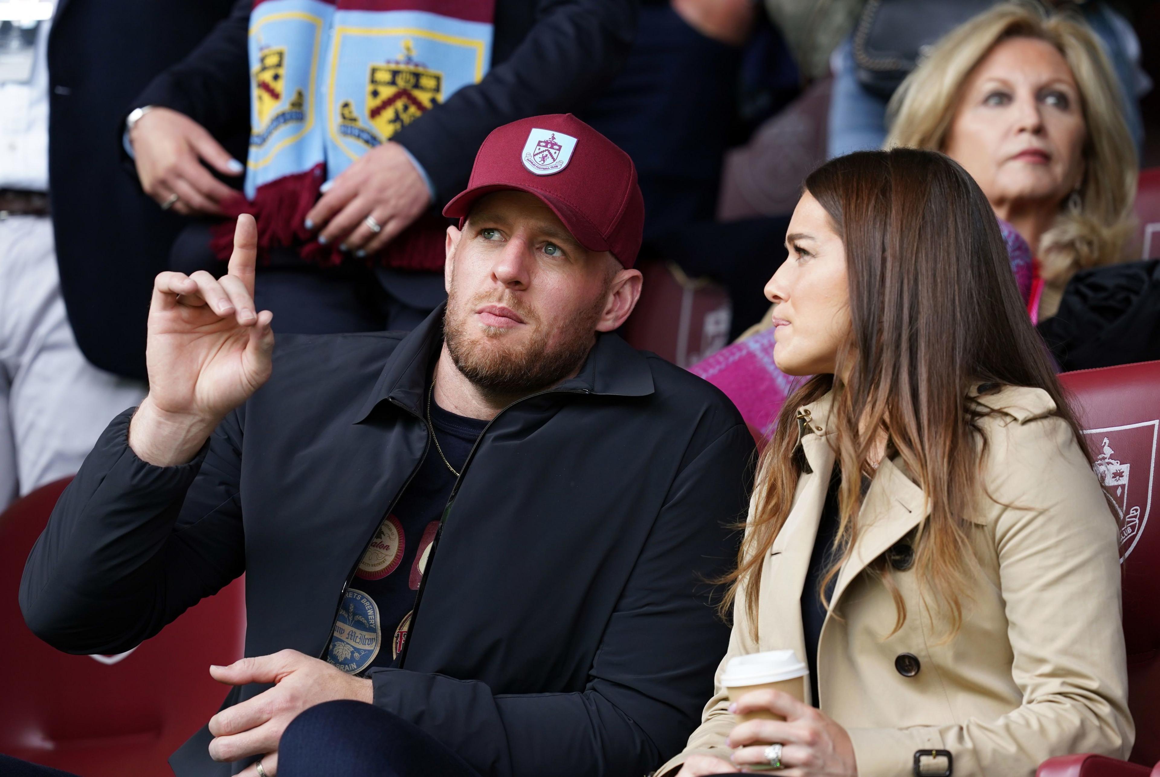 Burnley number  shareholders JJ Watt and Kealia Watt watching a Clarets game