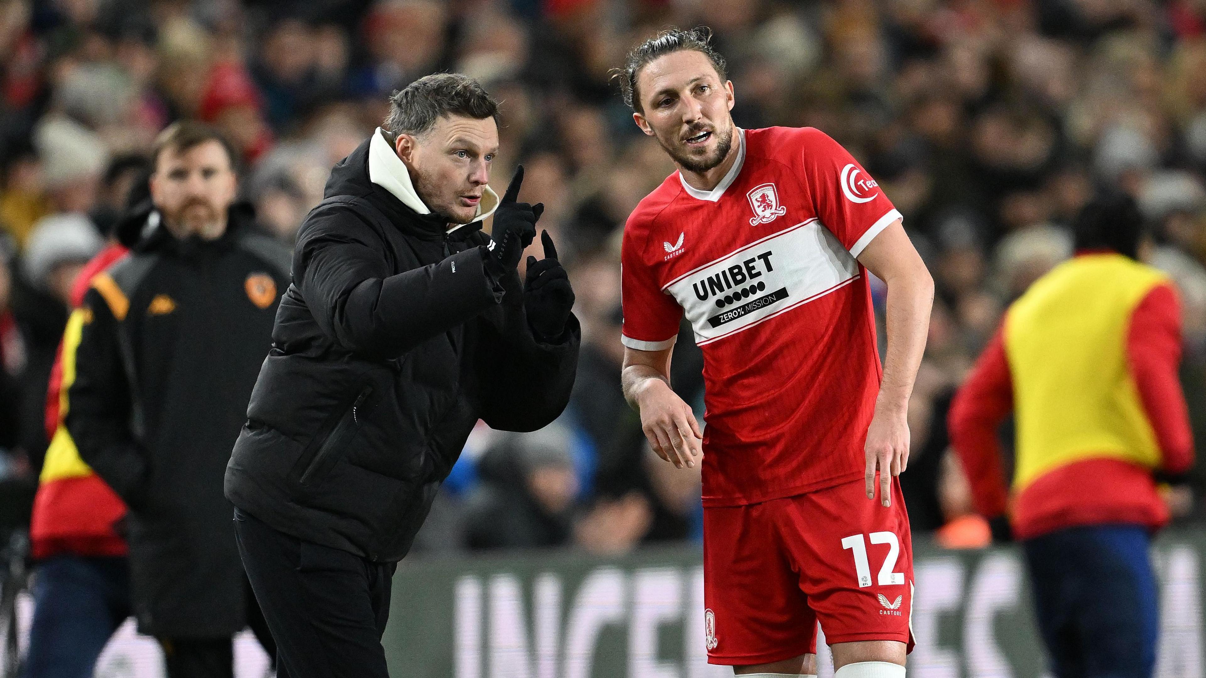 Kim Hellberg talking to Middlesbrough defender Luke Ayling during a match