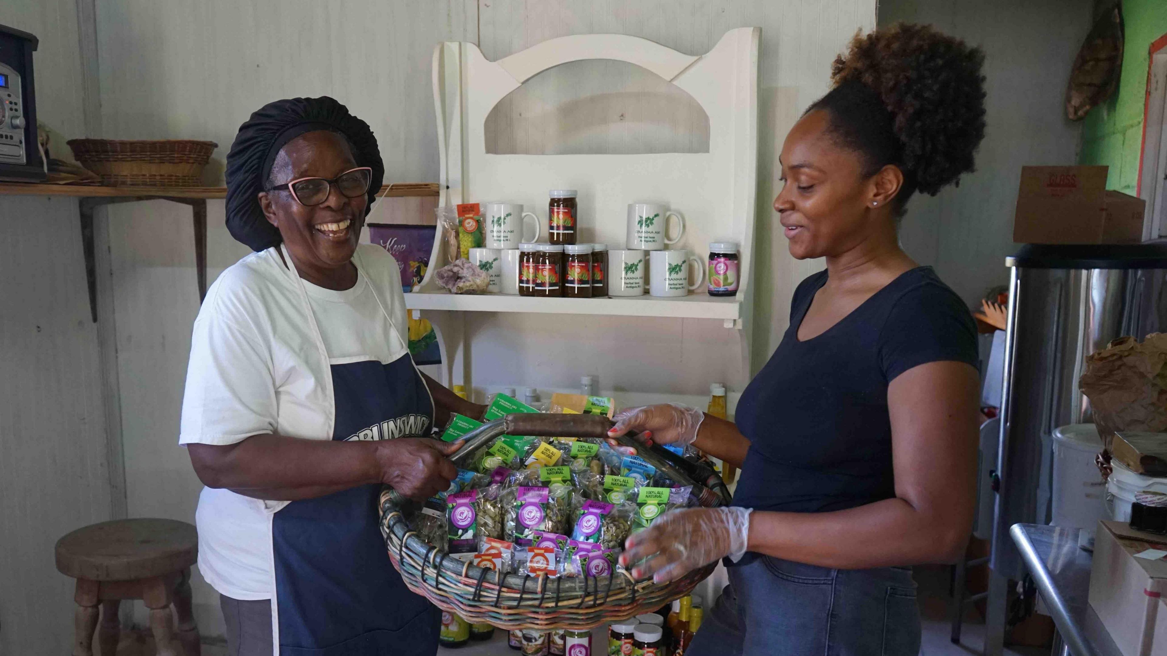 Novella Payne and her granddaughter Jenna Reid hold up a basket containing some of the products they make