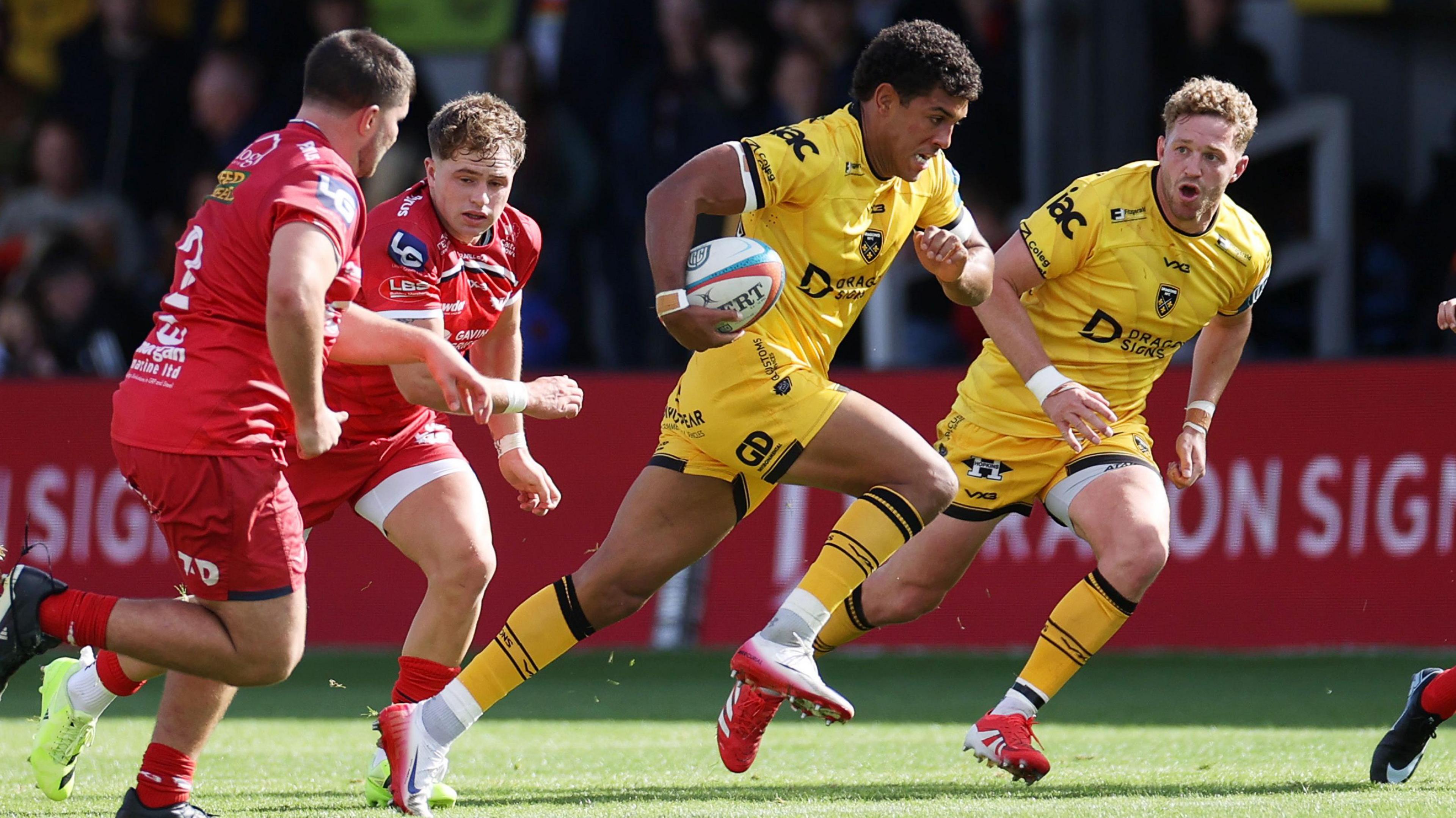 Rio Dyer runs through the Scarlets defence for the Dragons