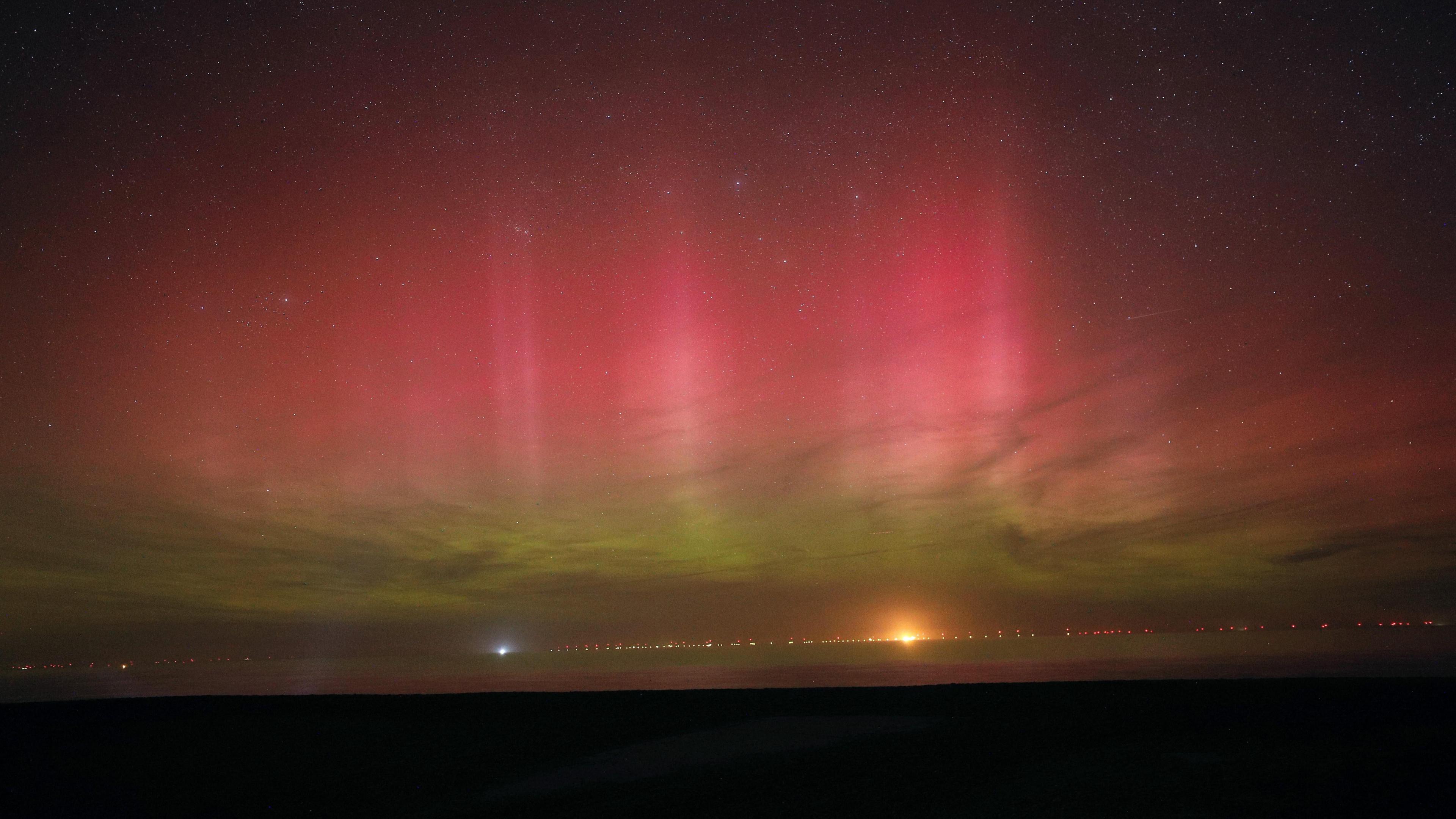 photo of the northern lights with the picture filled with reds and greens