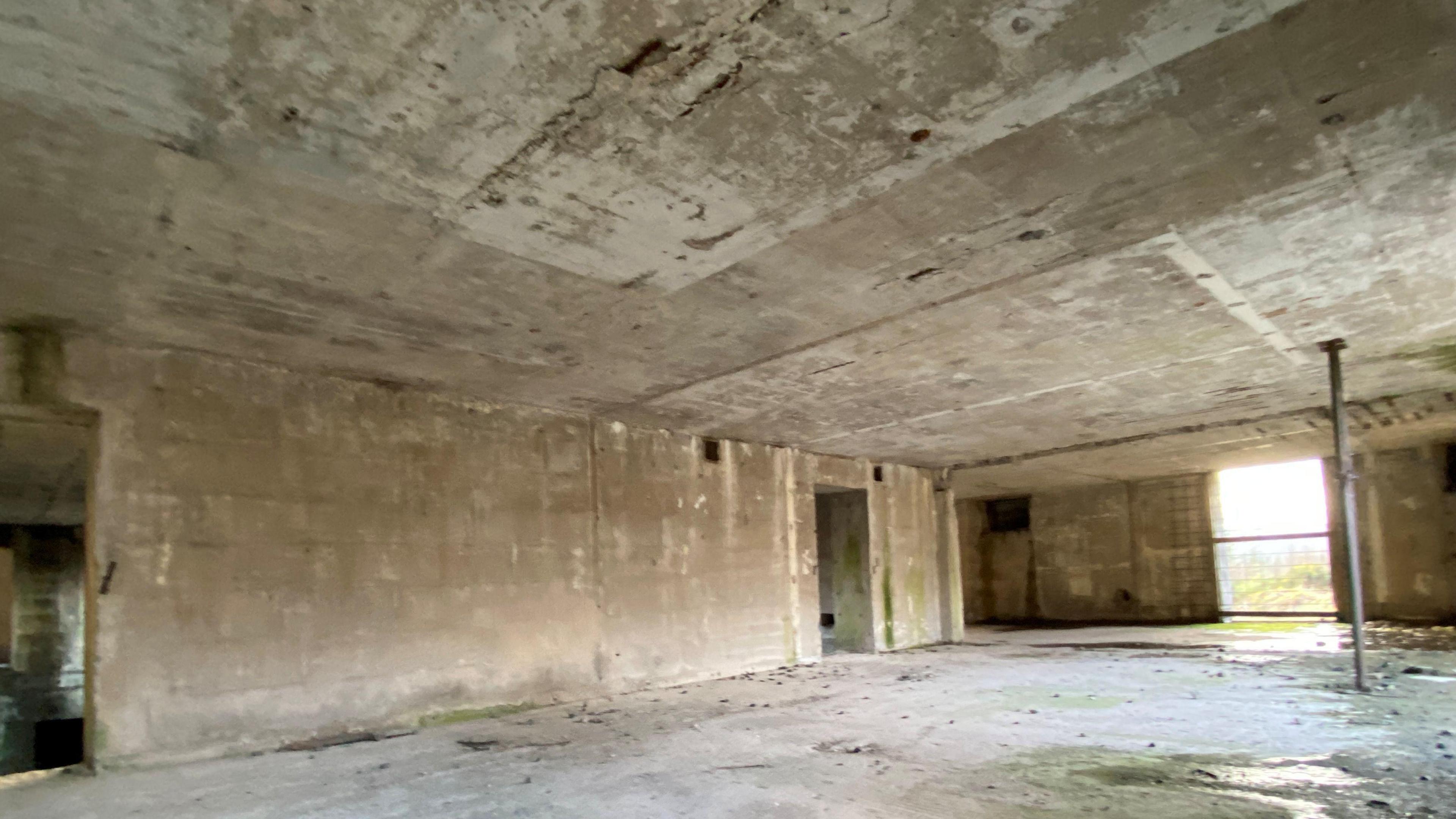 The inside of a long abandoned anti aircraft room, totally empty 