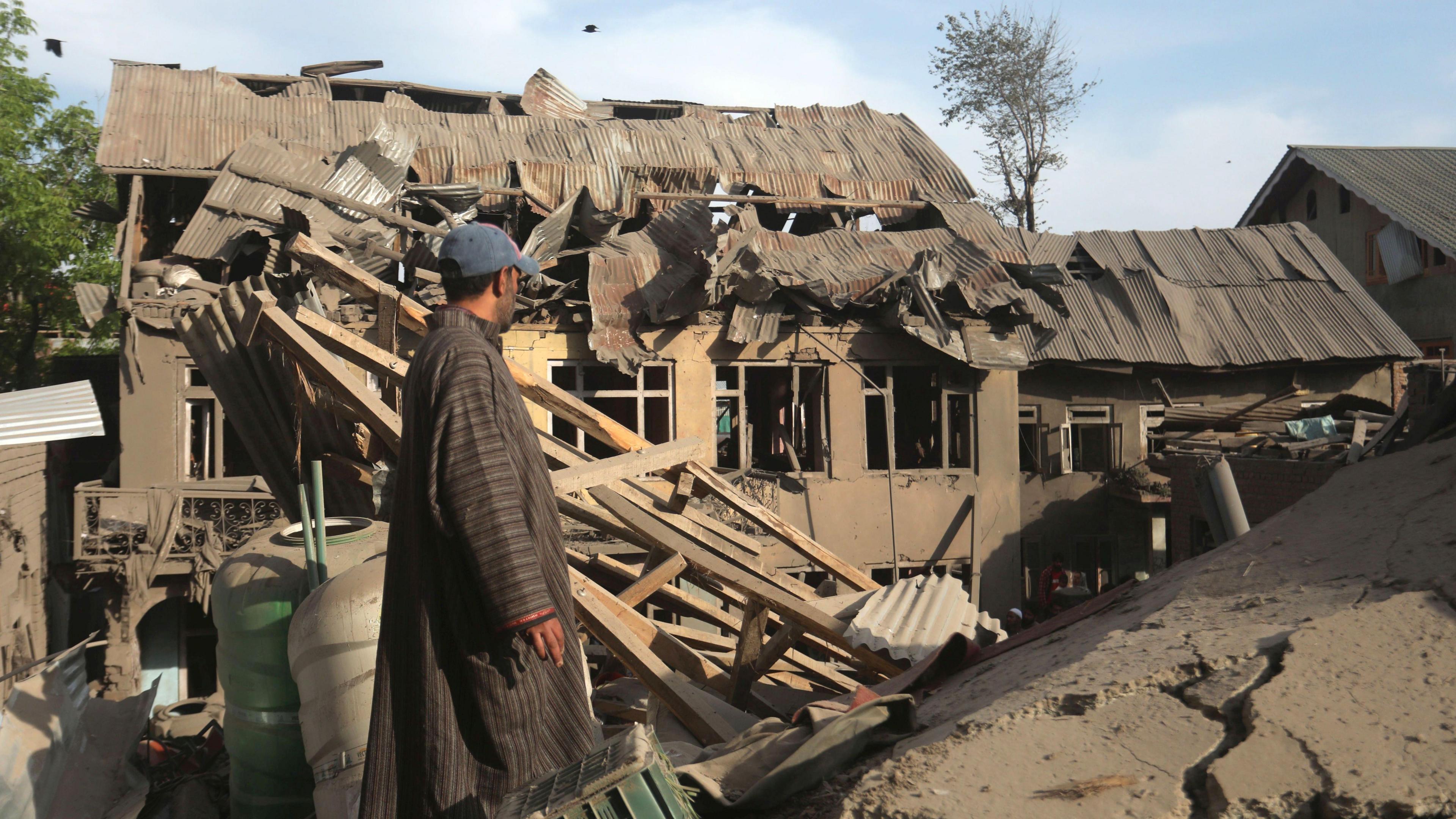 A man looks the debris of demolished houses related to the family of Ahsan Ul Haq Sheikh, who officials say was involved in the Pahalgam attack, in Murran village of Pulwama, south of Srinagar, India, 26 April 2025.