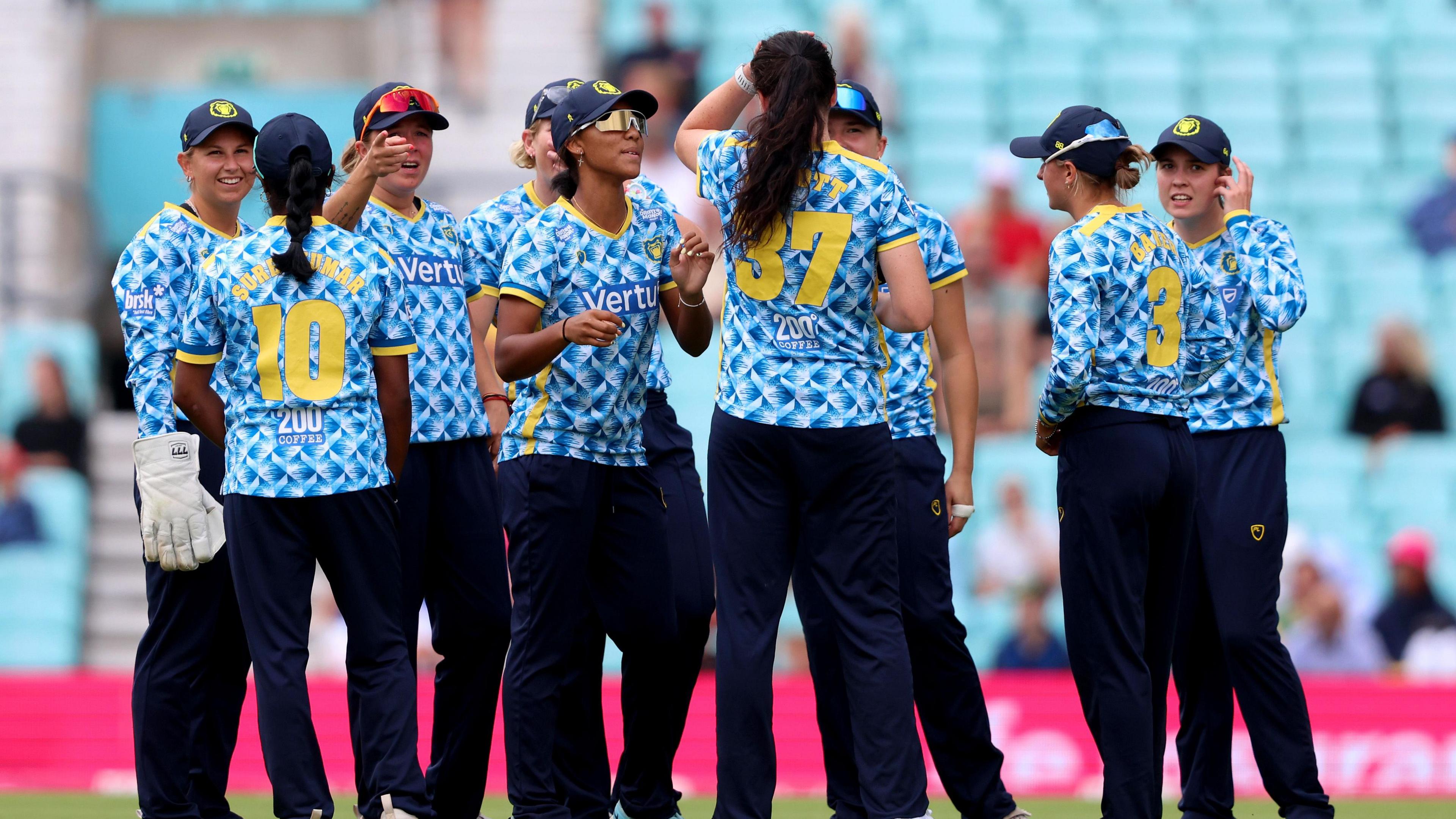 The Bears players celebrate a wicket