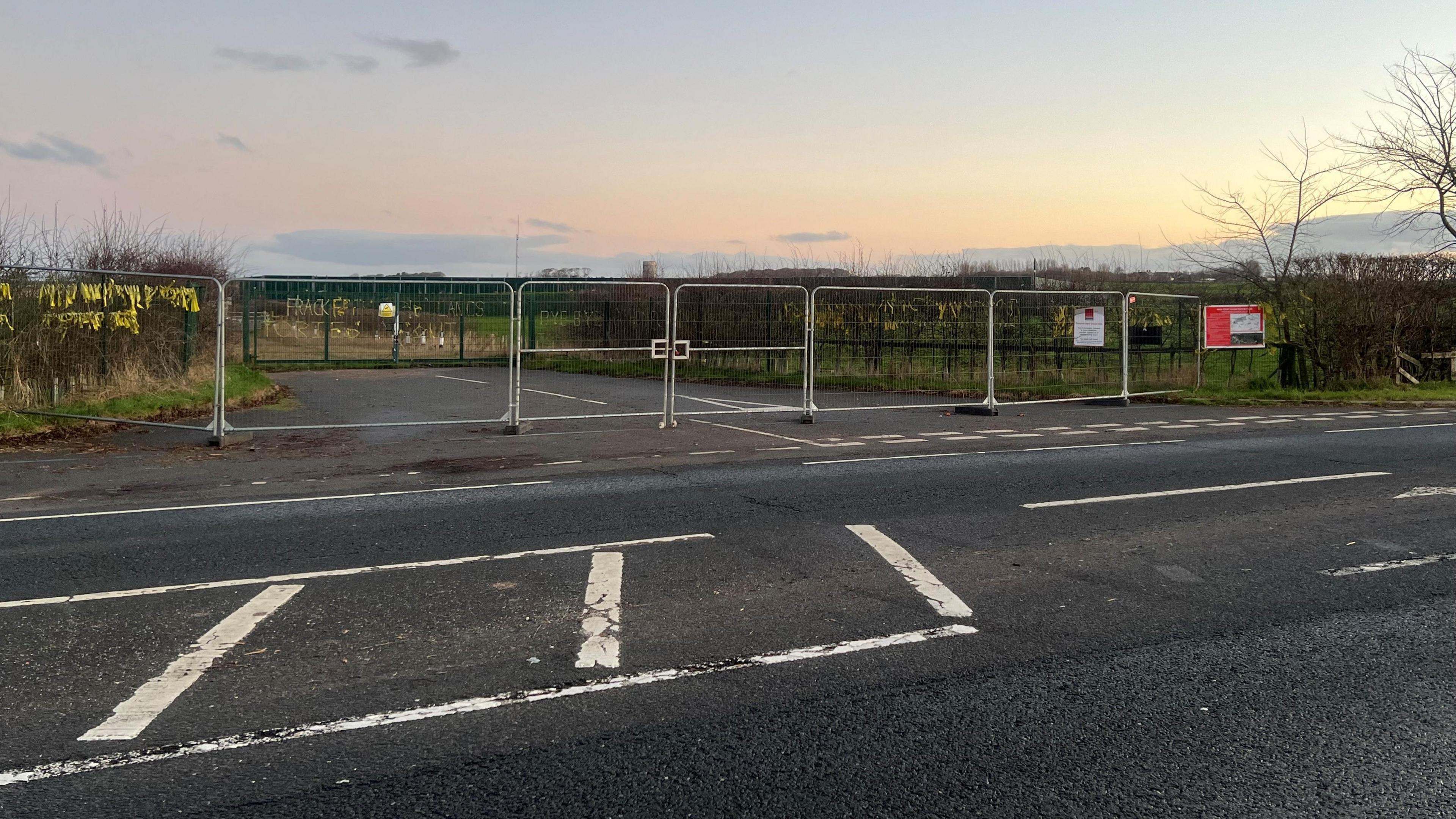 Entrance to Cuadrilla's site on the A583 Preston New Road between Preston and Blackpool showing fences blocking off the entrance and fields in the background