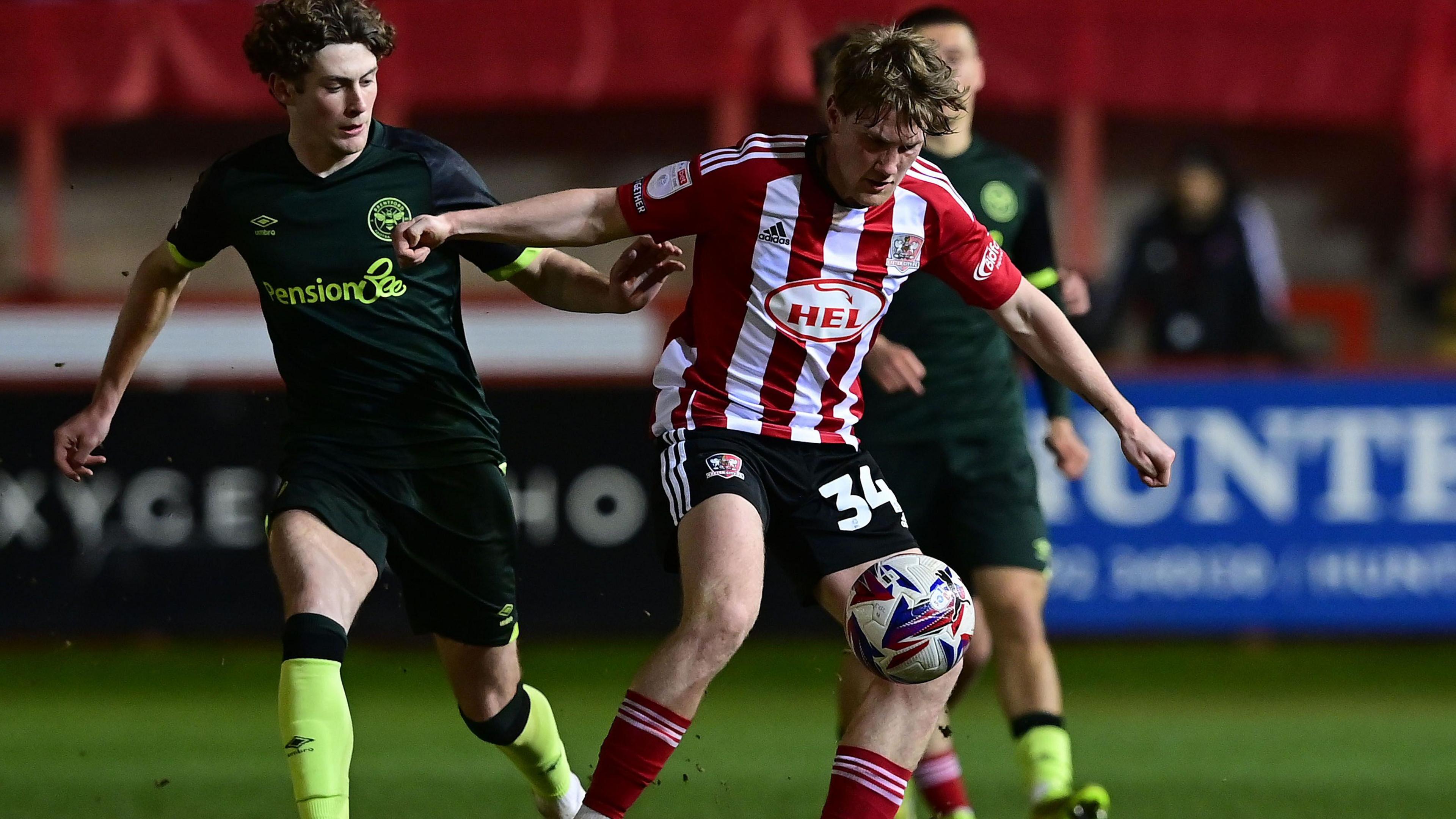 Ben Krauhaus challenges for the ball for Brentford v Exeter