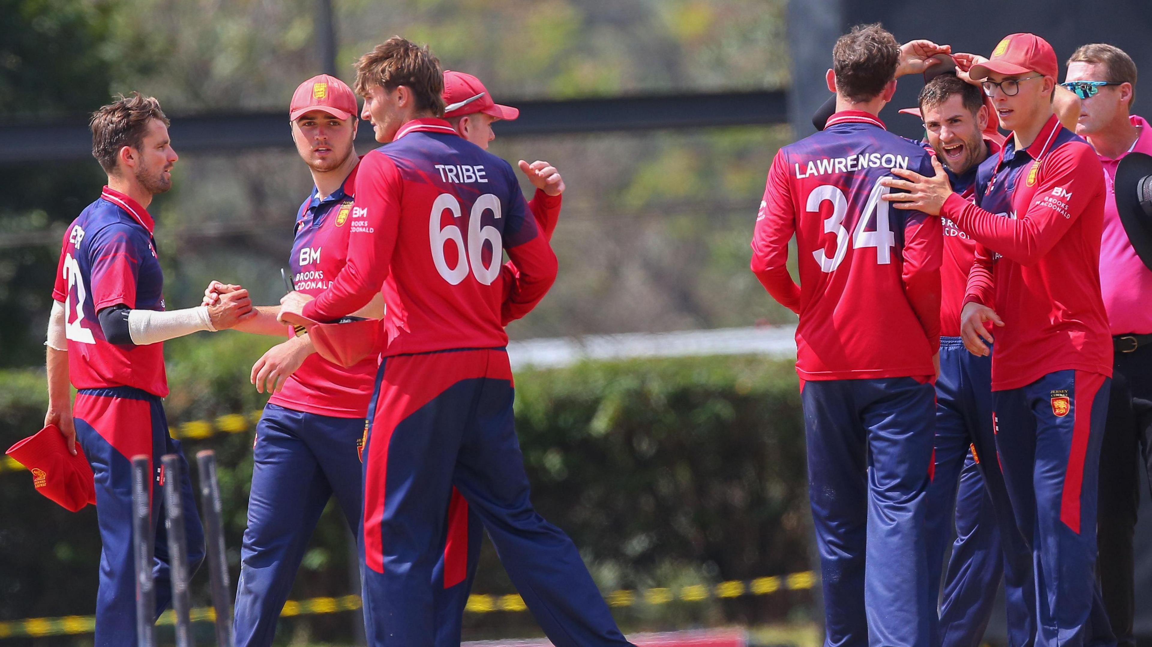 Jersey players celebrate a wicket