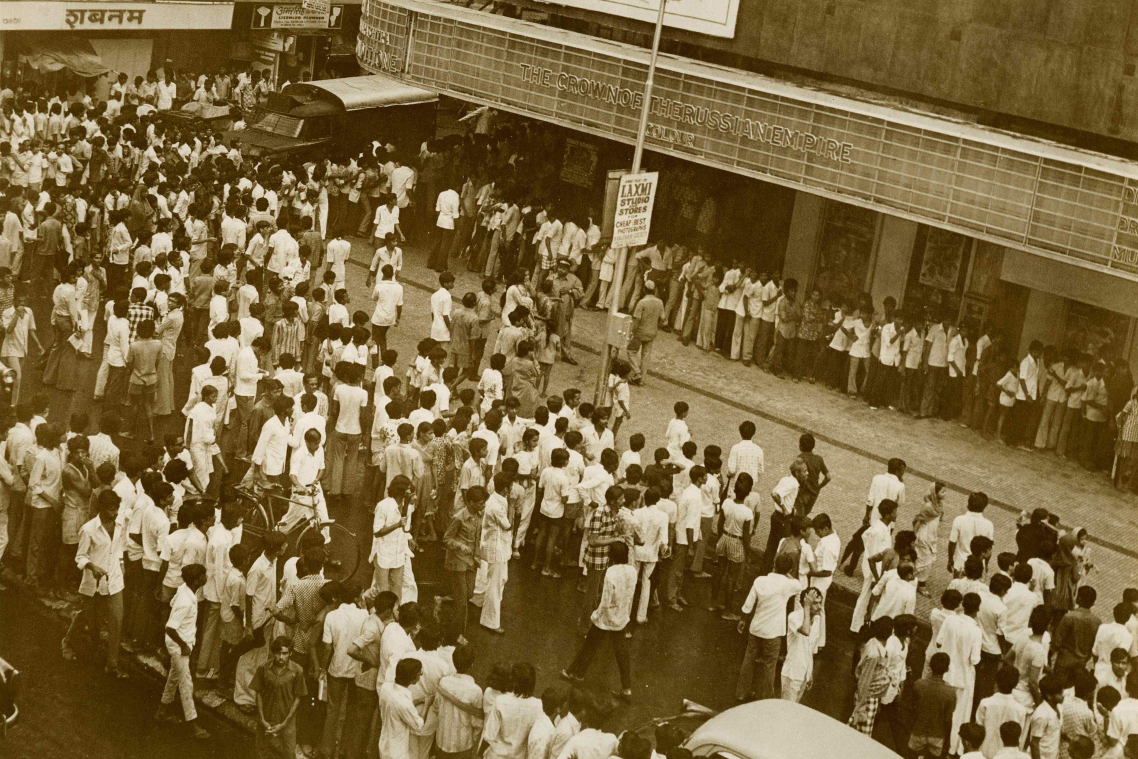 A sepia-toned image of a queue outside Mumbai's Minerva theatre where Sholay ran for more than five years.