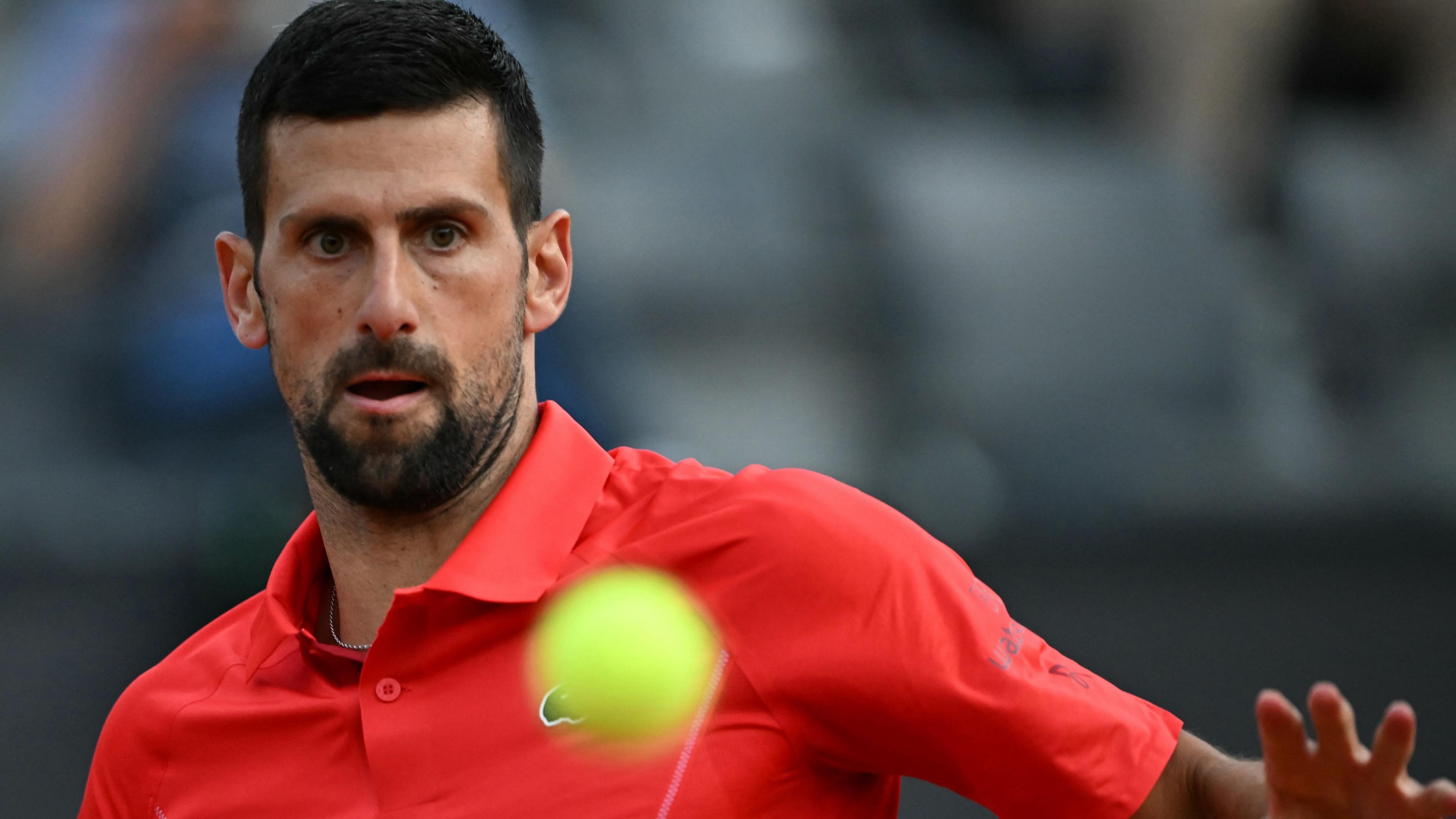 Novak Djokovic watches the ball