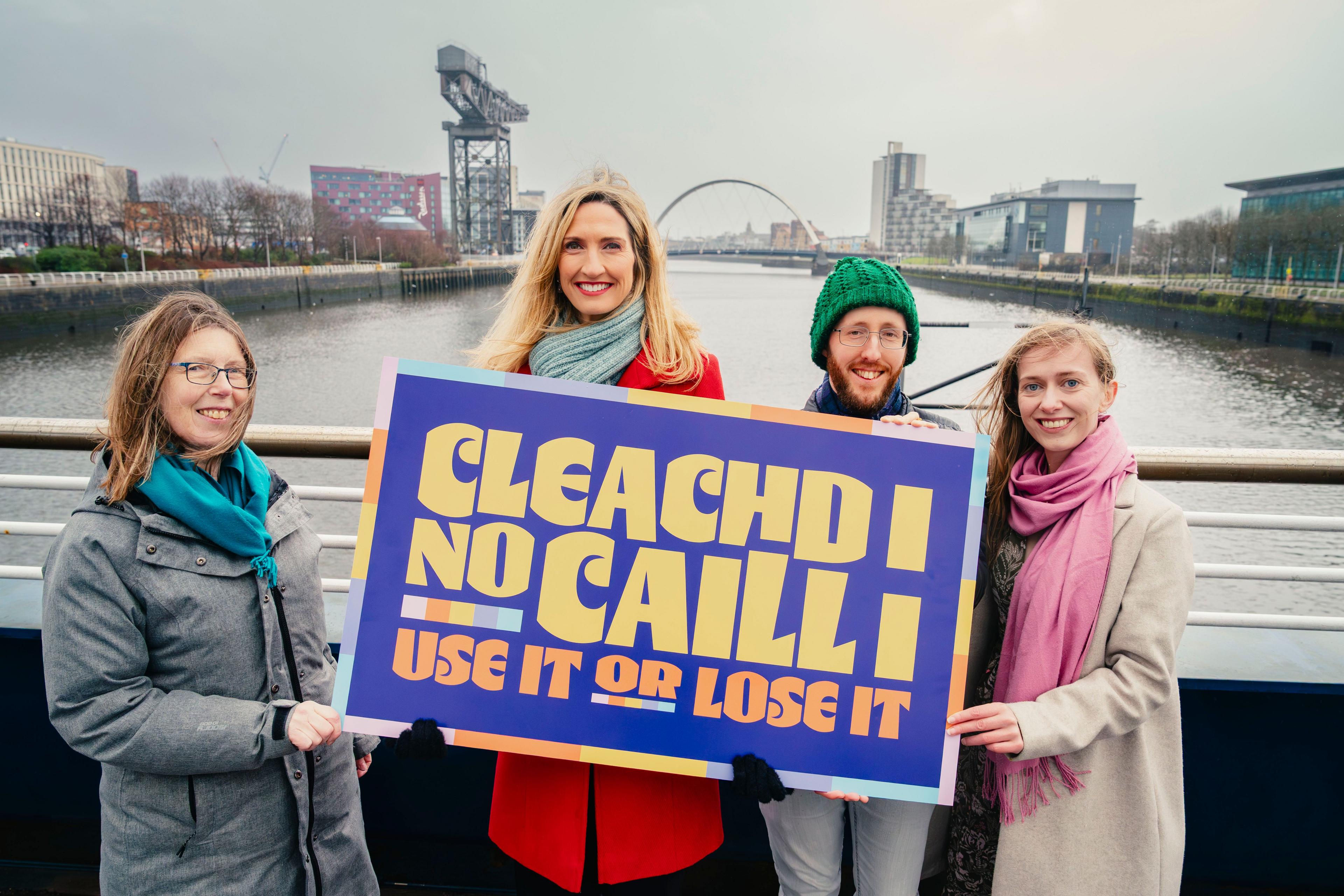 Sgioba Seachdain na Gàidhlig le soidhne air a bheil Cleachd i no Caill i is iad a' cur air bhog Seachdain na Gàidhlig 2026