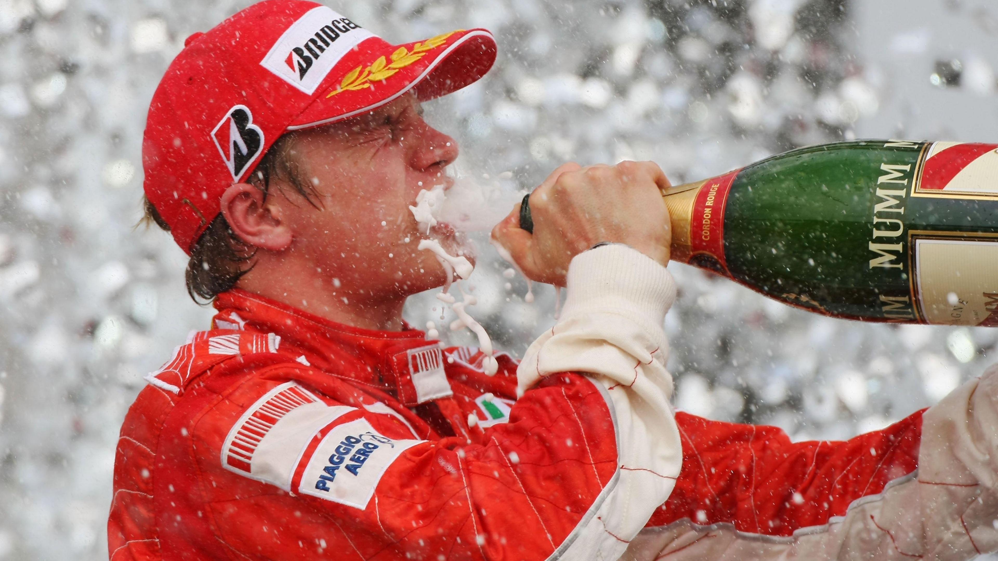 Ferrari's Kimi Raikkonen drinks champagne from a bottle on the podium after winning the 2007 Brazilian Grand Prix